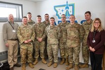 Members of the 22nd Space Operations Squadron, detachment 1, pose for with a photo with STARBASE Montana chapter leadership at the Montana Air National Guard Base, Great Falls, Montana, Feb. 2, 2023. STARBASE is the premiere Department of Defense science, technology, engineering and math program, offering 25-hours of education to 5th graders across the country. (U.S. Air Force photo by Airman 1st Class Elijah Van Zandt)