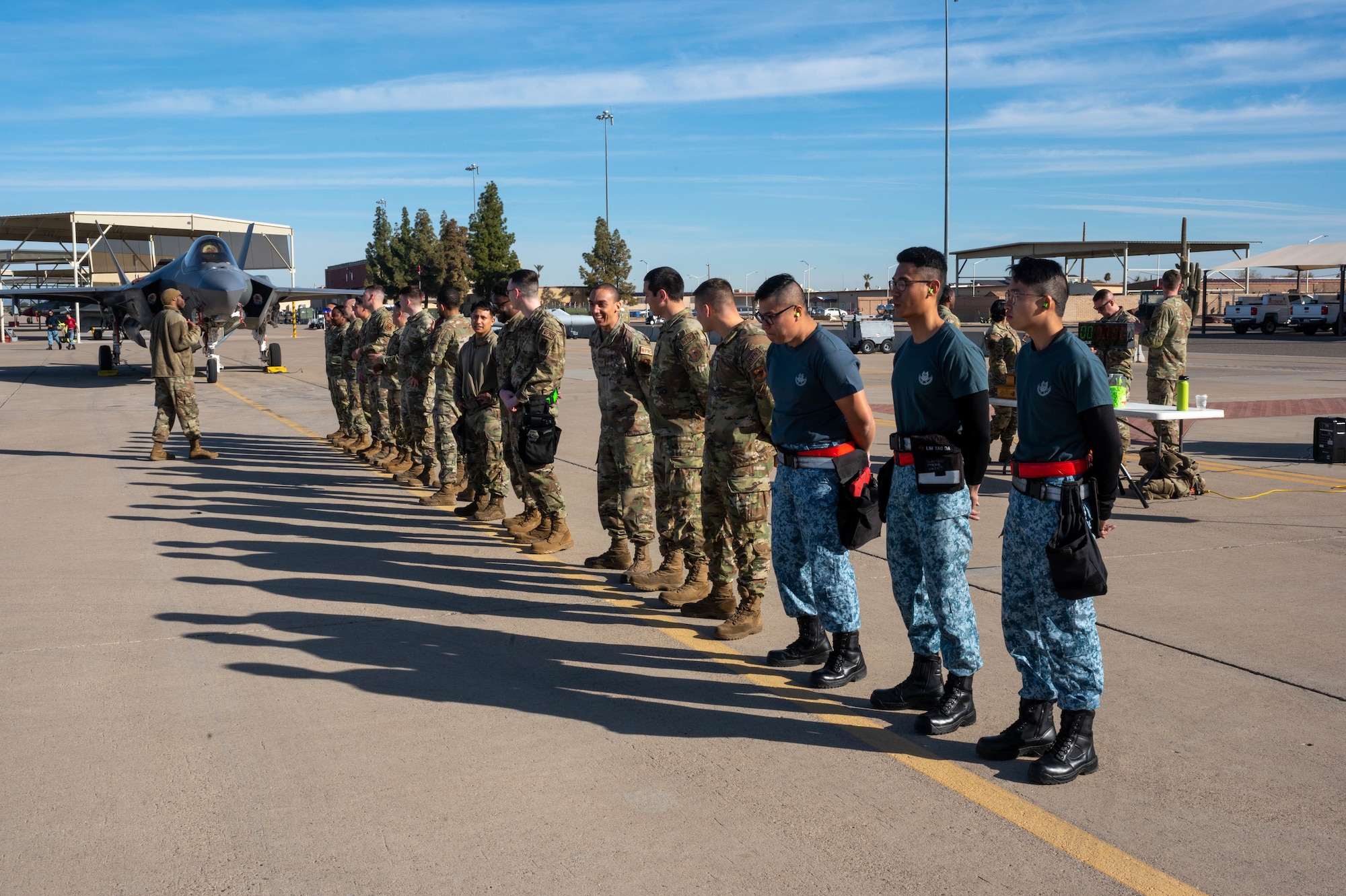 Airmen assigned to the 56th Maintenance Group and Singaporean service members prepare for the annual weapons load competition Feb. 3, 2023, at Luke Air Force Base, Arizona.