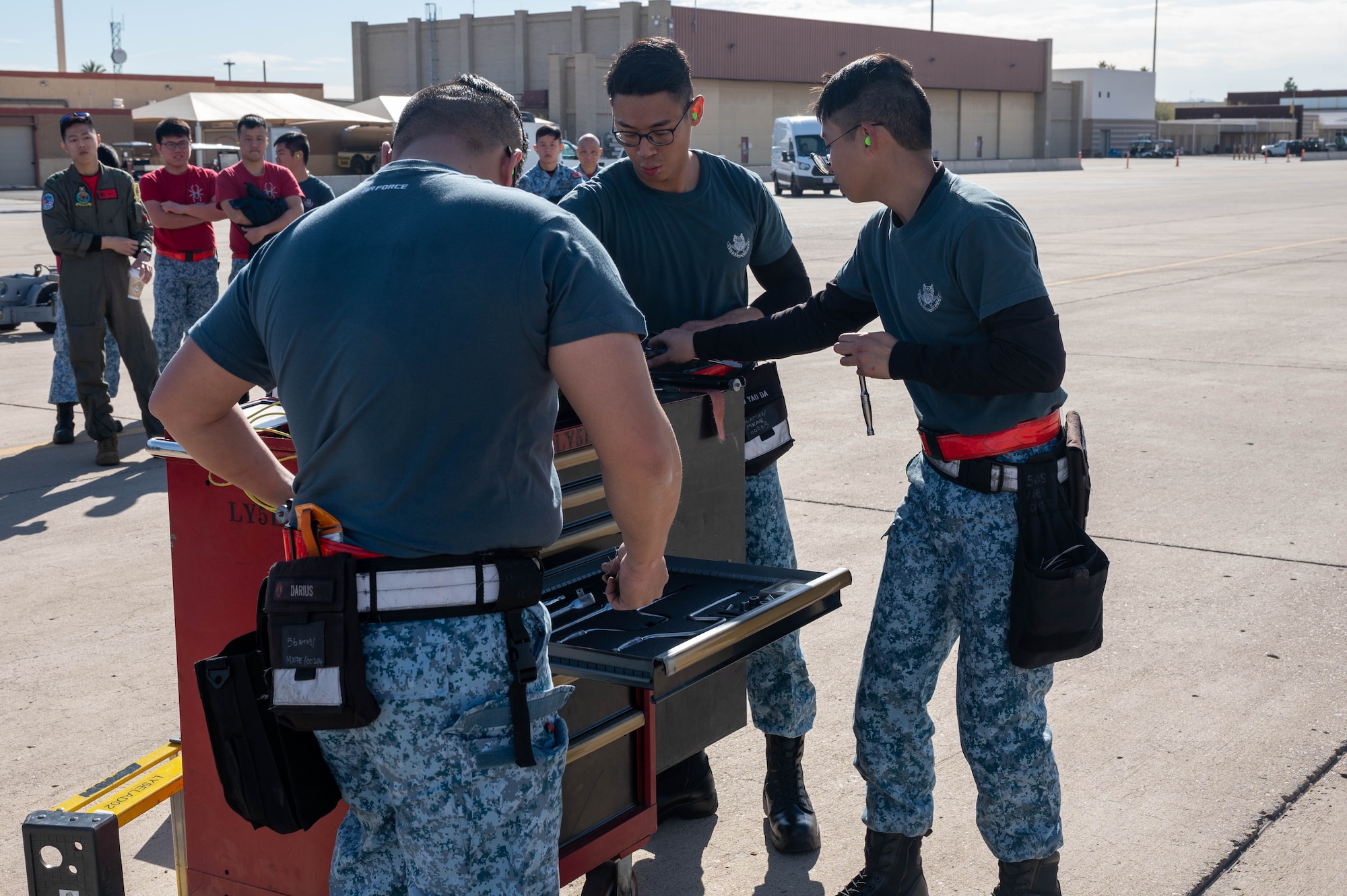 Singaporean air force ME2 Darius Lee, ME1 Wong Boon Soon and ME1 Lim Yao Da, 425th Aircraft Maintenance Unit maintainers, organize their crew toolbox during the annual weapons load competition Feb. 3, 2023, at Luke Air Force Base, Arizona.