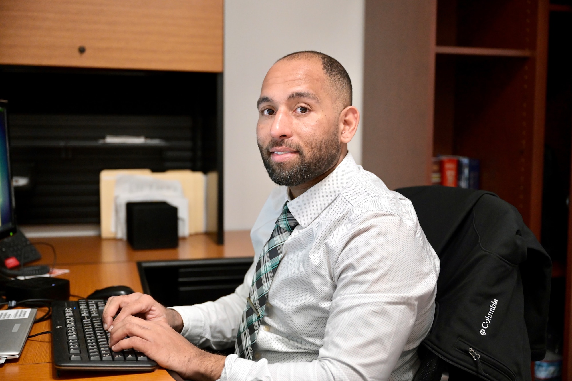 Dr. Paul T. Stearns sits at his desk, working on diversity and inclusion projects.