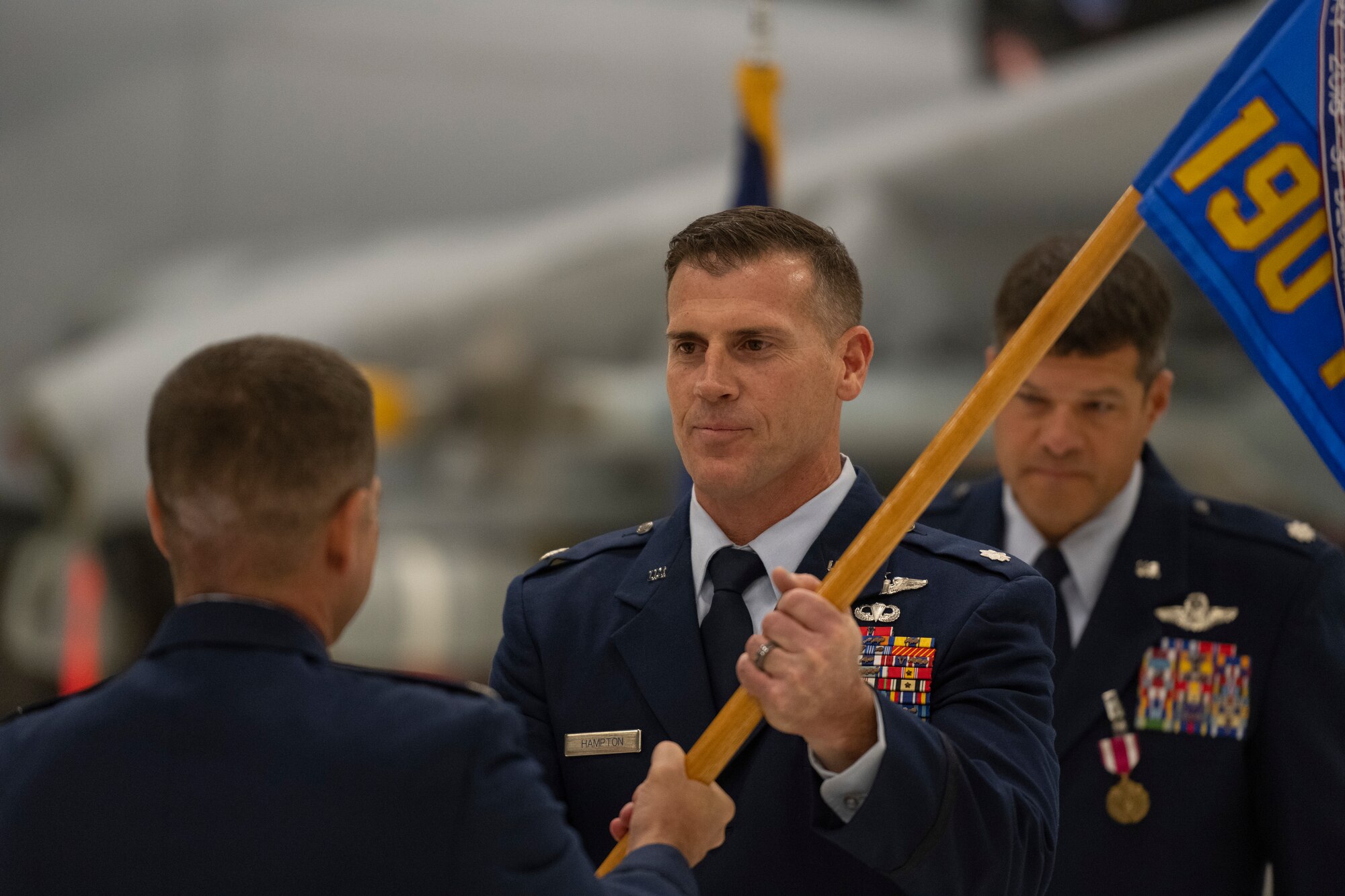 Airmen exchange a guidon during a change of command