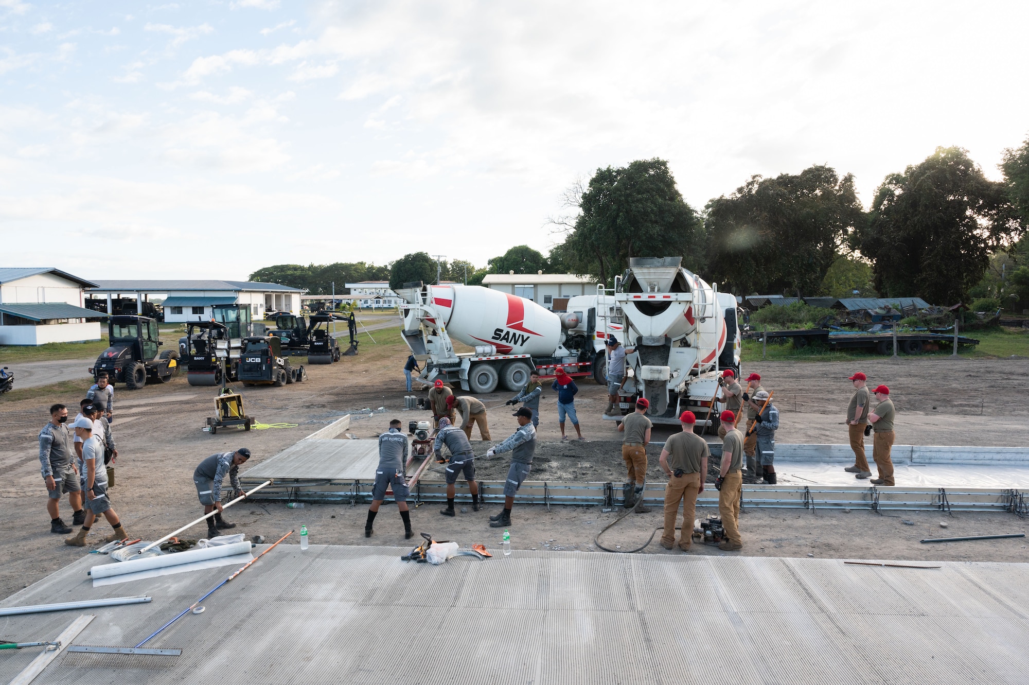 Airmen from the 819th RED HORSE Squadron out of Malmstrom Air Force Base, Montana, assist the Philippine Air Force in pouring concrete as part of a Field Training Event at Basa Air Base, Philippines, January 25, 2023. The training event allowed both units to exchange knowledge and best practices in pouring a concrete pad which will be used as a future training site for airfield damage repair. (U.S. Air Force photo by Tech. Sgt. Hailey Haux)