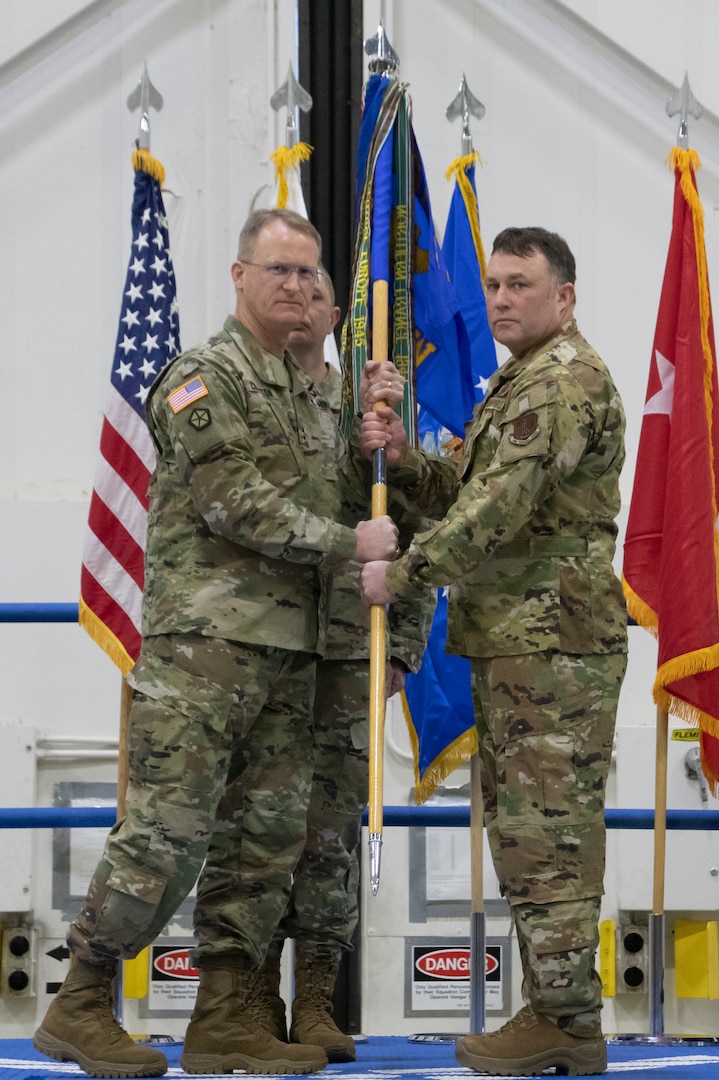 Maj. Gen. Levon Cumpton, Adjutant General of the Missouri National Guard, presents the 131st Bomb Wing guidon to new wing commander Col. Jared P. Kennish, during a change of command ceremony at Whiteman Air Force Base, Missouri, Feb. 3, 2023. During the ceremony Col. Jared P. Kennish assumed command of the 131st Bomb Wing from Col. Matthew D. Calhoun. (U.S. Air National Guard photo by Senior Airman Kelly C. Ferguson)