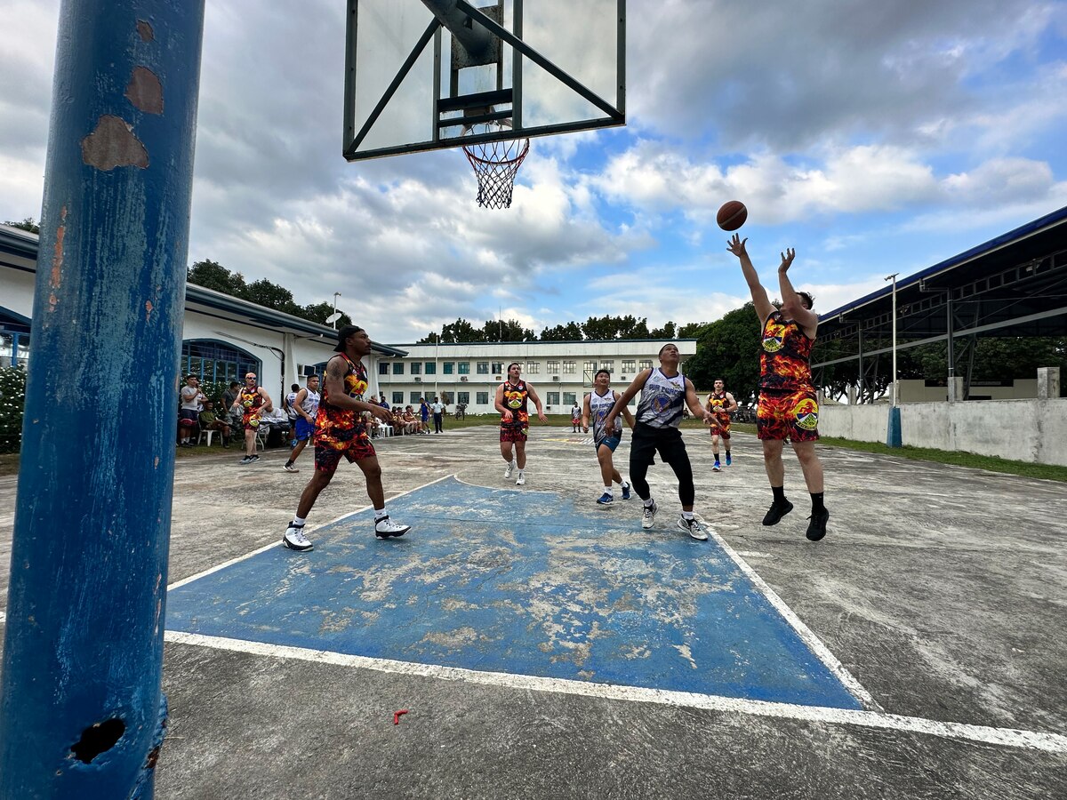 Senior Airman Arthur Hettinger, 819th RED HORSE Squadron Pavements and Equipment operator, attempts a shot during a pick-up basketball game against the Philippine Air Force unit they have been working alongside the past two weeks for a Field Training Event at Basa Air Base, Philippines, February 1, 2023. While it was a close game, the RED HORSE Squadron won 75 to 73. (U.S. Air Force photo by Tech. Sgt. Hailey Haux)