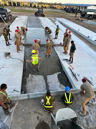 Airmen from the 819th RED HORSE Squadron out of Malmstrom Air Force Base, Montana, assist Philippine Air Force Airmen in pouring concrete as part of a Field Training Event at Basa Air Base, Philippines, January 25, 2023. This event was one of many that took place in the Philippines over the course of two weeks to include training together on maintenance, hot pit refueling, airfield damage repair, and logistics. (U.S. Air Force photo by Tech. Sgt. Hailey Haux)