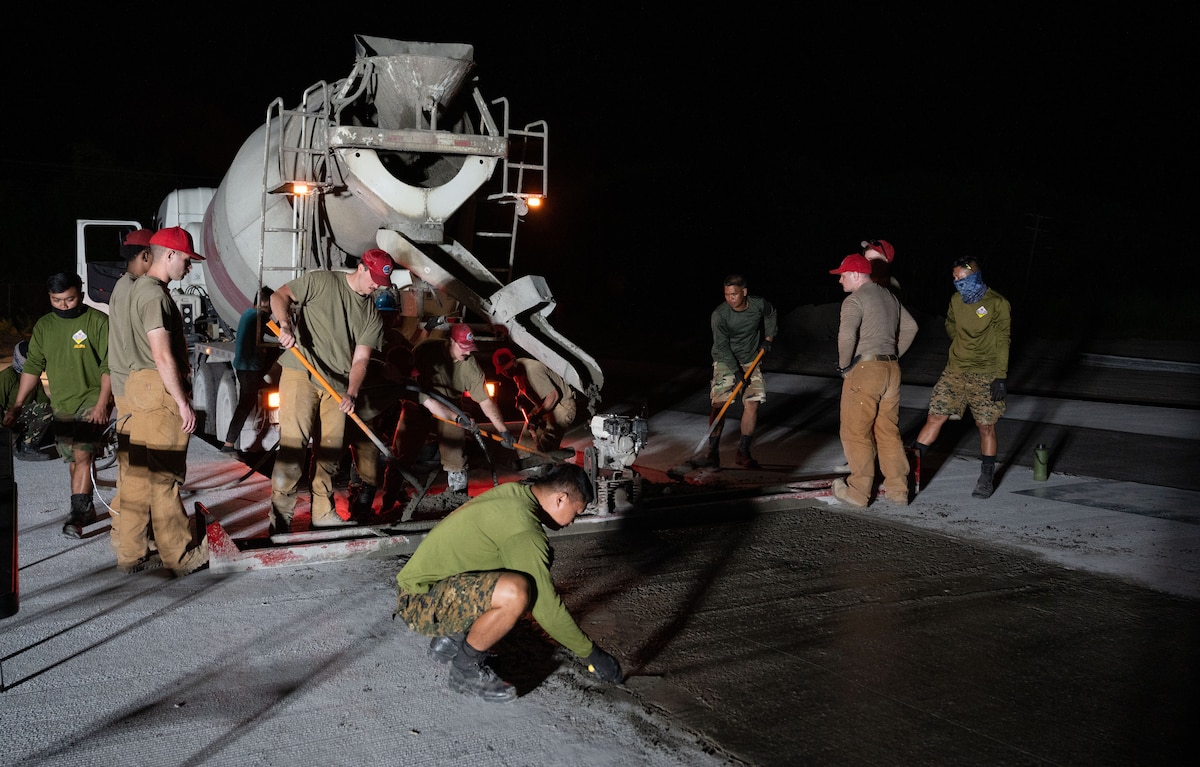 Airmen from the 819th RED HORSE Squadron out of Malmstrom Air Force Base, Montana, assist Philippine Air Force Airmen in pouring concrete as part of a Field Training Event at Basa Air Base, Philippines, January 25, 2023. The training event allowed both units to exchange knowledge and best practices in pouring a concrete pad which will be used as a future training site for airfield damage repair. (U.S. Air Force photo by Tech. Sgt. Hailey Haux)