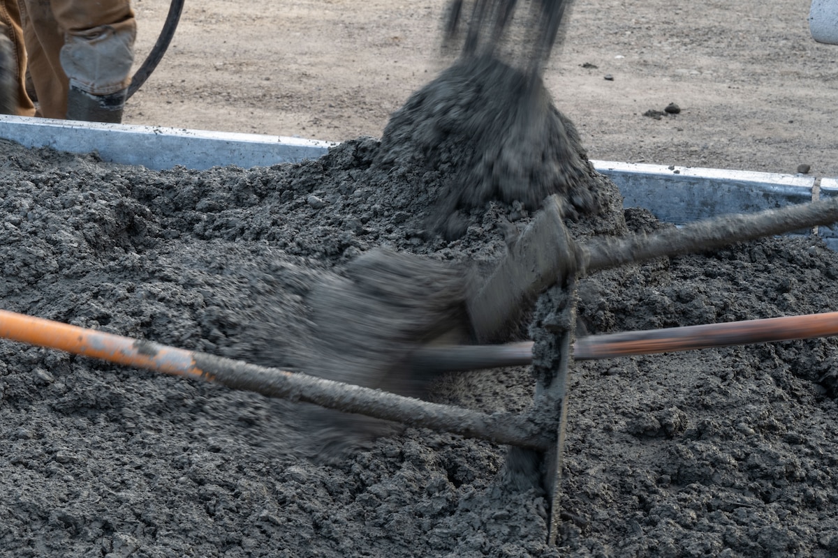 Airmen from the 819th RED HORSE Squadron out of Malmstrom Air Force Base, Montana, assist Philippine Air Force Airmen in pouring concrete as part of a Field Training Event at Basa Air Base, Philippines, January 25, 2023. This event was one of many that took place in the Philippines over the course of two weeks, which included subject matter expert exchanges on maintenance, hot pit refueling, airfield damage repair, and logistics. (U.S. Air Force photo by Tech. Sgt. Hailey Haux)