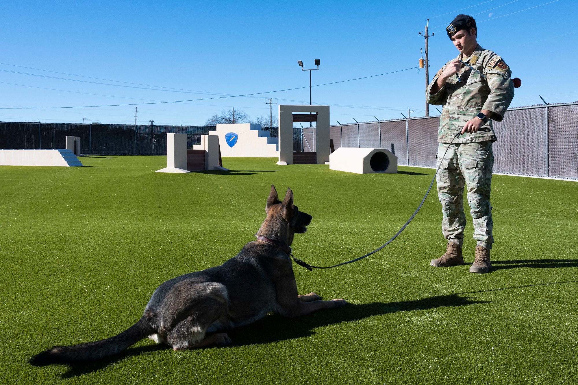 U.S. Air Force Staff Sgt. Charles Gaines, 47th Security Forces Squadron military working dog trainer, instructs Tuko, a military working dog, to follow basic commands at the 47th Security Forces Squadron military working dog training area at Laughlin Air Force Base, Texas, on Jan. 13, 2023. Military working dogs provide a variety of services, including the detection of explosives and drug searches, tracking of personnel and suspects, patrol of restricted areas, and protection of military installations. (U.S. Air Force photo by Airman 1st Class Kailee Reynolds)