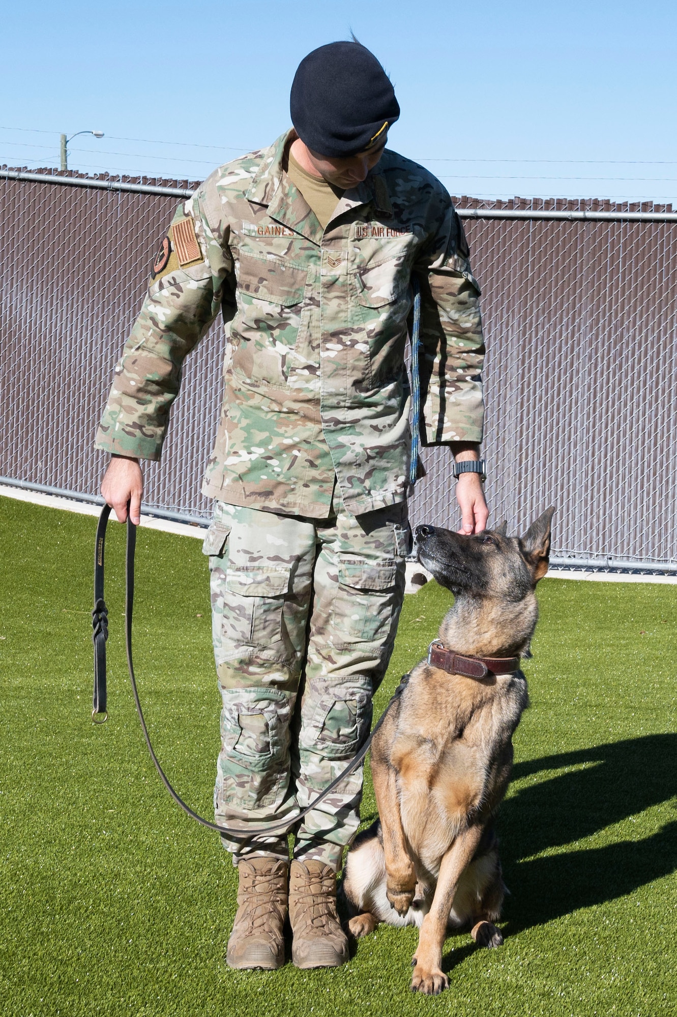 U.S. Air Force Staff Sgt. Charles Gaines, 47th Security Forces Squadron military working dog trainer, poses with Tuko, a military working dog, at the 47th Security Forces Squadron military working dog training area at Laughlin Air Force Base, Texas, on Jan. 13, 2023. MWD handlers employ their dogs to conduct vehicle searches, and searches of open areas, buildings, and other locations for the detection of suspects, explosives or illegal drugs. (U.S. Air Force photo by Airman 1st Class Kailee Reynolds)