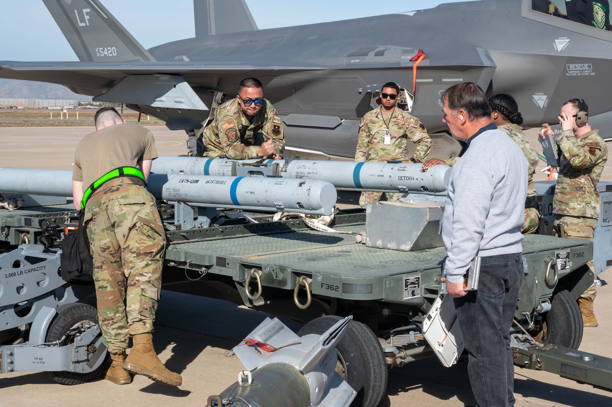 Airmen assigned to the 308th Aircraft Maintenance Unit prepare an AIM-120 AMRAAM missile during the annual weapons load competition Feb. 3, 2023, at Luke Air Force Base, Arizona.