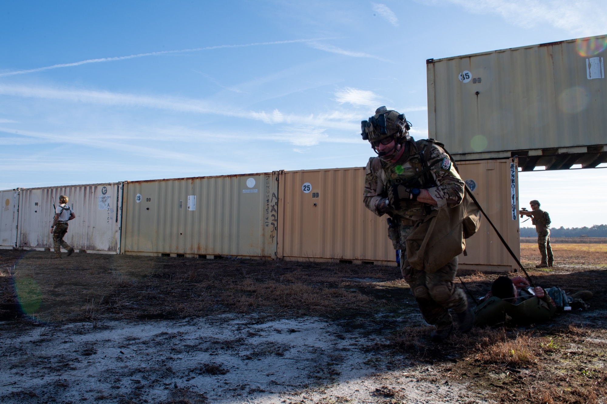 A photo of an Airmen pulling a patient.