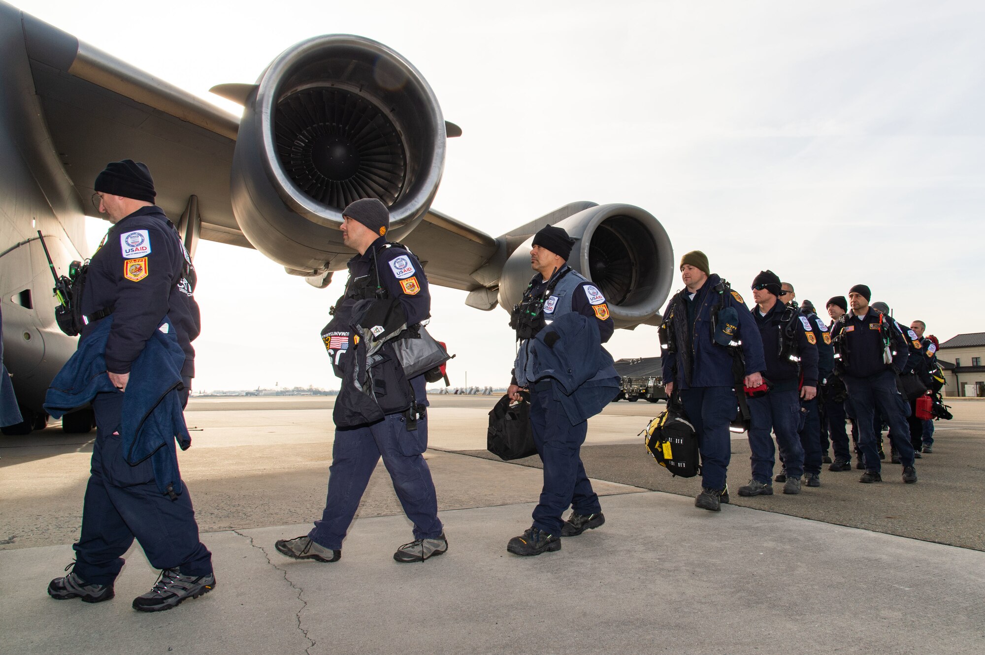 Members of Urban Search and Rescue Virginia Task Force 1, Fairfax County, Virginia, board a C-17 Globemaster III at Dover Air Force Base, Delaware, Feb. 7, 2023. The U.S. Agency for International Development (USAID) is mobilizing emergency humanitarian assistance to respond to the devastating impacts in Türkiye following the worst earthquake to hit the region in almost a century. (U.S. Air Force photo by Roland Balik)