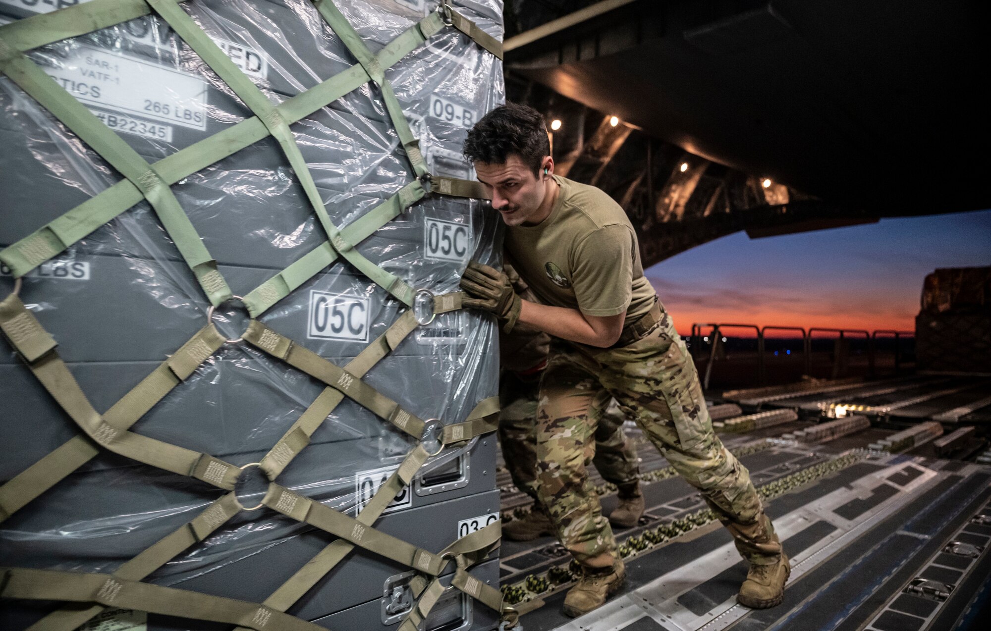 Senior Airman Garrett LaMarche, 6th Airlift Squadron loadmaster, pushes a cargo pallet onto a C-17 Globemaster III on Dover Air Force Base, Delaware, Feb. 7, 2023. The U.S. Agency for International Development (USAID) is mobilizing emergency humanitarian assistance to respond to the devastating impacts in Türkiye following the worst earthquake to hit the region in almost a century. (U.S. Air Force photo by Staff Sgt. Marco A. Gomez)