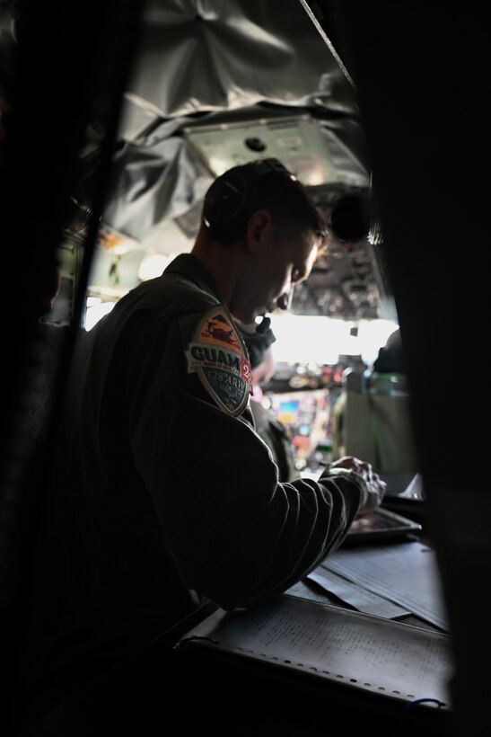 U.S. Air Force Master Sgt. Justin Jung, 128th Air Refueling Wing boom operator, checks information on a tablet before takeoff at Andersen Air Force Base, Guam, Feb. 3, 2023.