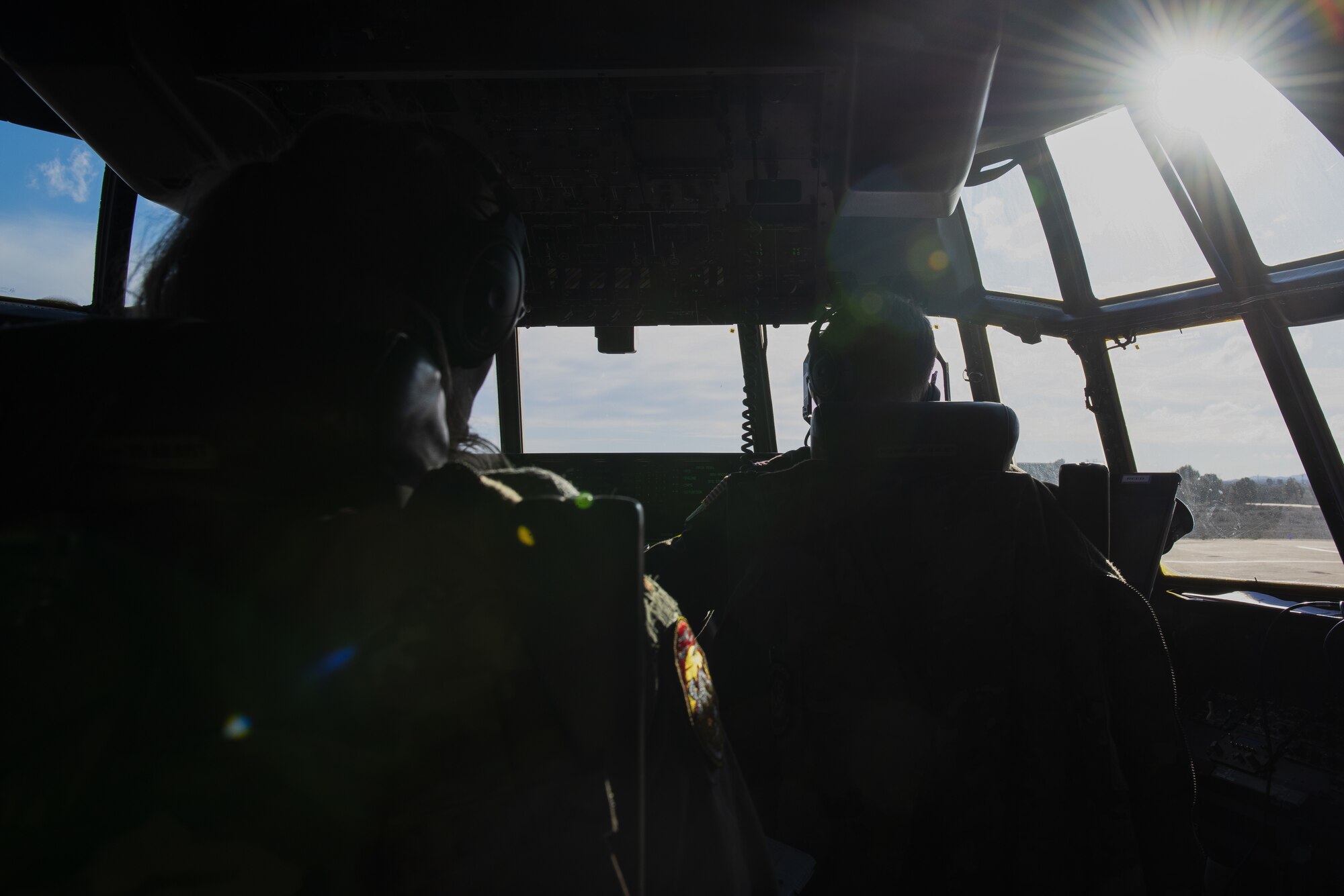 A man is flying a C-130J