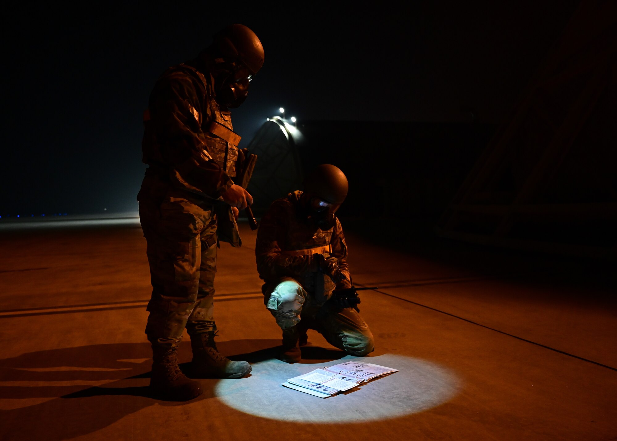 U.S Air Force Master Sgt.’s David Varady (left), 80th Fighter Generation Squadron (FGS) flightline expediter, and Robert Pray, 80th FGS crew chief, examine post-attack reconnaissance sweep checklists during a training event at Kunsan Air Base, Republic of Korea, Feb. 6, 2023. During the training, the 80th FGS Airmen were evaluated on their ability to respond to a simulated unexploded ordnance and return the flightline to normal operations. (U.S. Air Force photo by Staff Sgt. Isaiah J. Soliz)