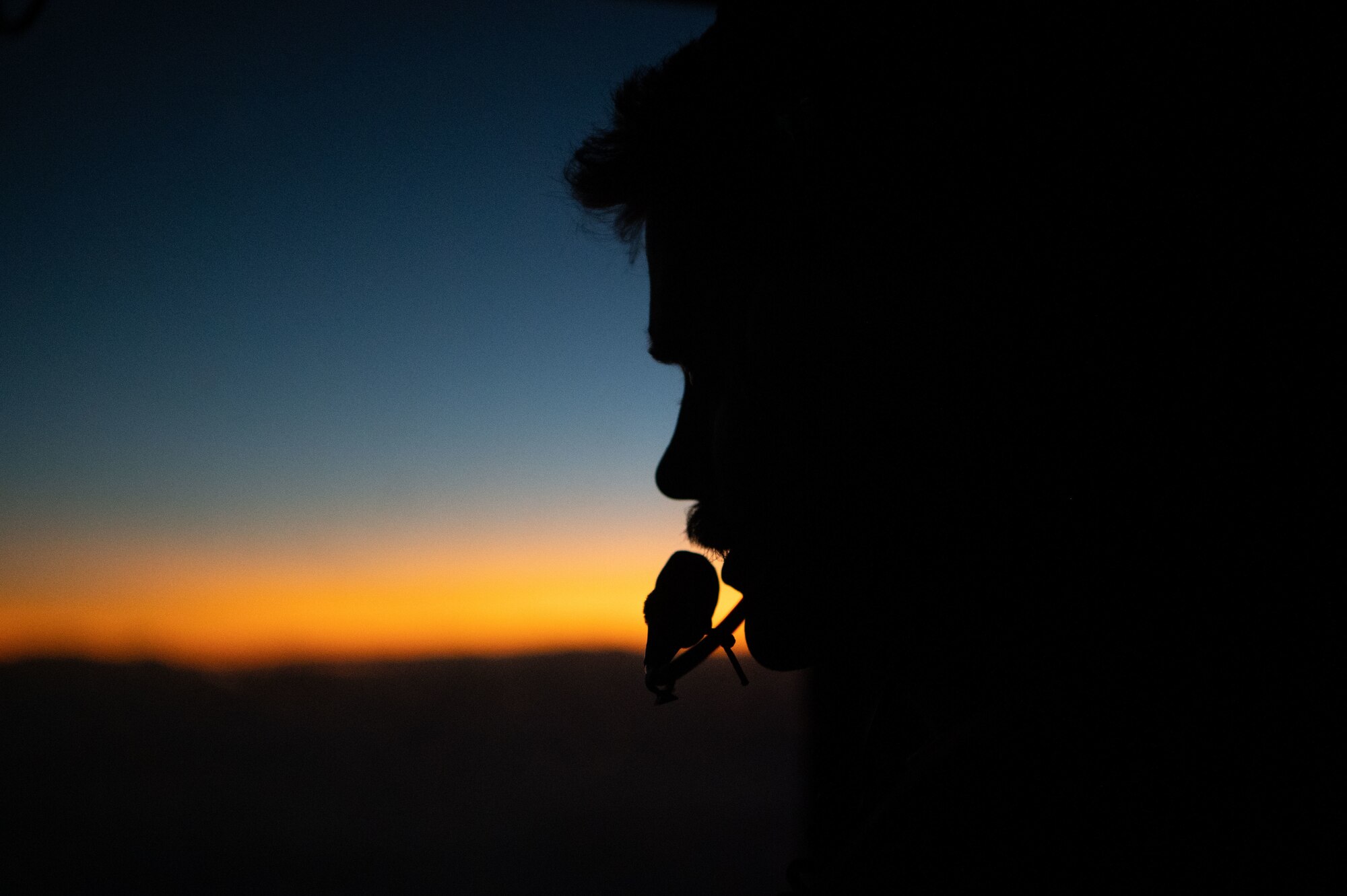 Silhouette of a crew chief at sunset