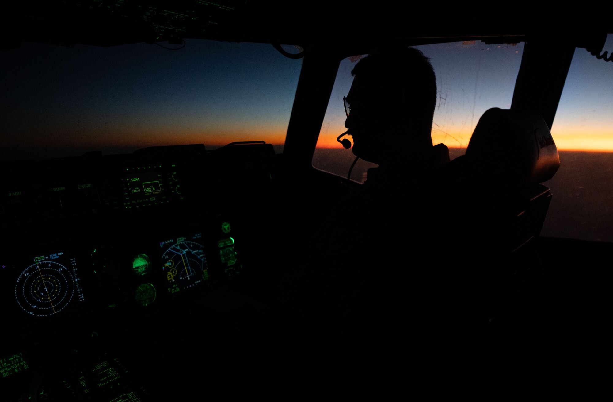 Photo of pilot flying at sunset