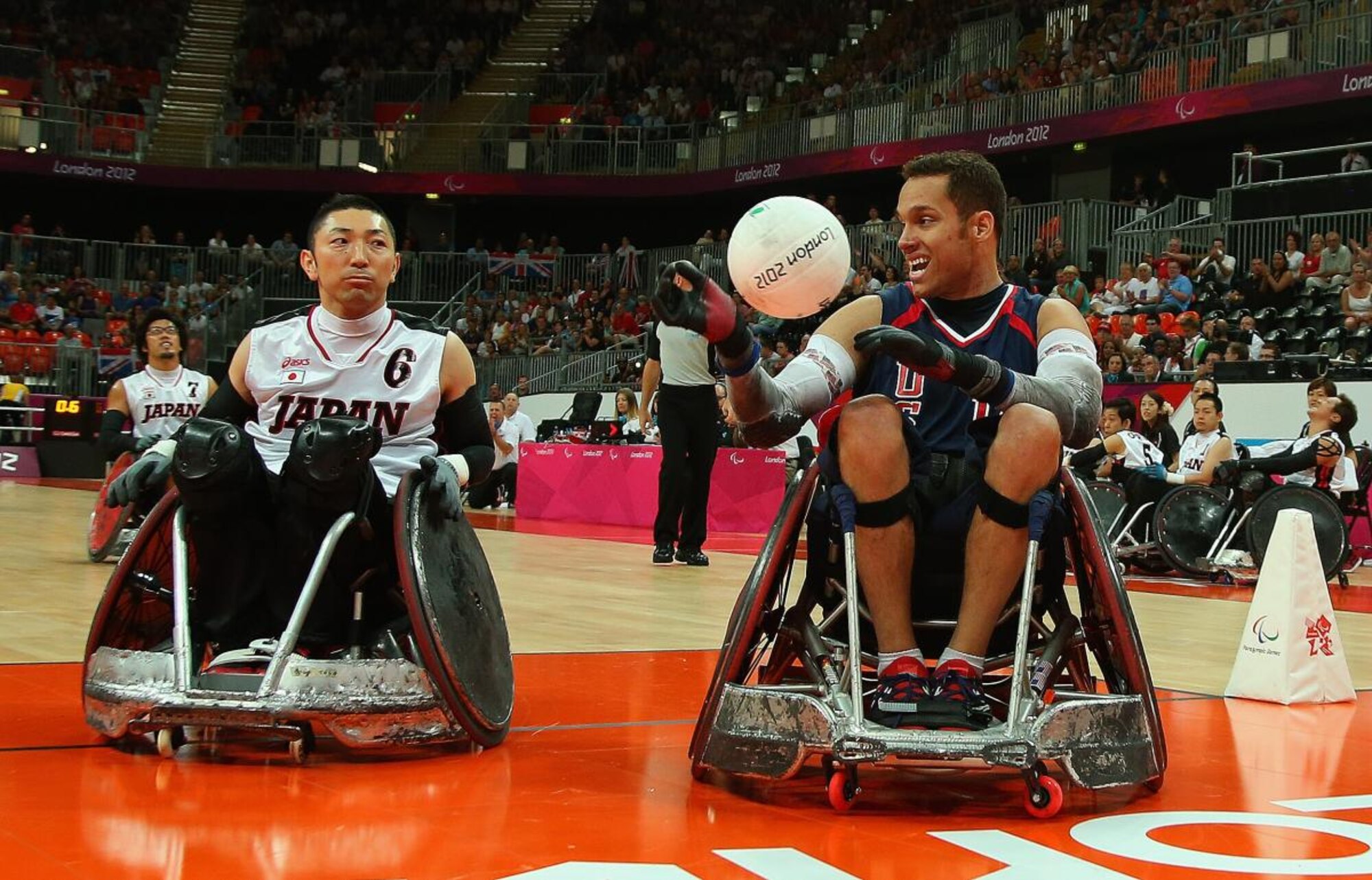 two athletes in wheelchairs play rugby