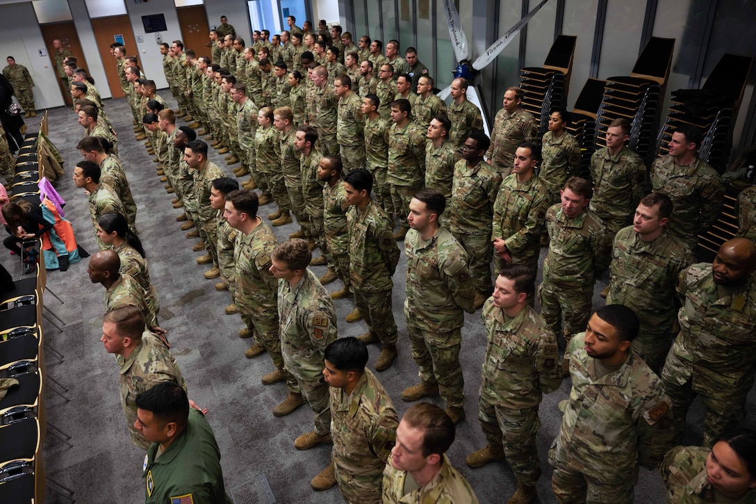 Service members stand at attention during an award ceremony.