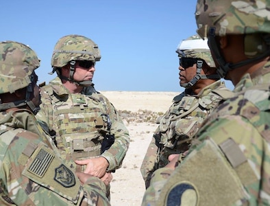 Brig. Gen. Walter L. Mercer, left, visits with Command Sgt. Maj. Irving Reed Jr, right, Dec. 9, 2016, in Qatar. The Soldiers serve as security forces as various sites in Qatar. (Photo by Sgt. 1st Class Terra C. Gatti, 116th Military Engagement Team)