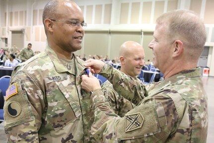 Maj. Gen. Timothy P. Williams, the Adjutant General of Virginia, presents Command Sgt. Maj. Irving Reed Jr. with the  Governor's National Service Medal May 21, 2017, in Roanoke, Virginia, in recognition of his federal active duty service conducting security operations in Qatar from May 2016 to April 2017. The battalion and several companies also were recognized with national- and state-level training readiness awards. (U.S. National Guard photo by Cotton Puryear)