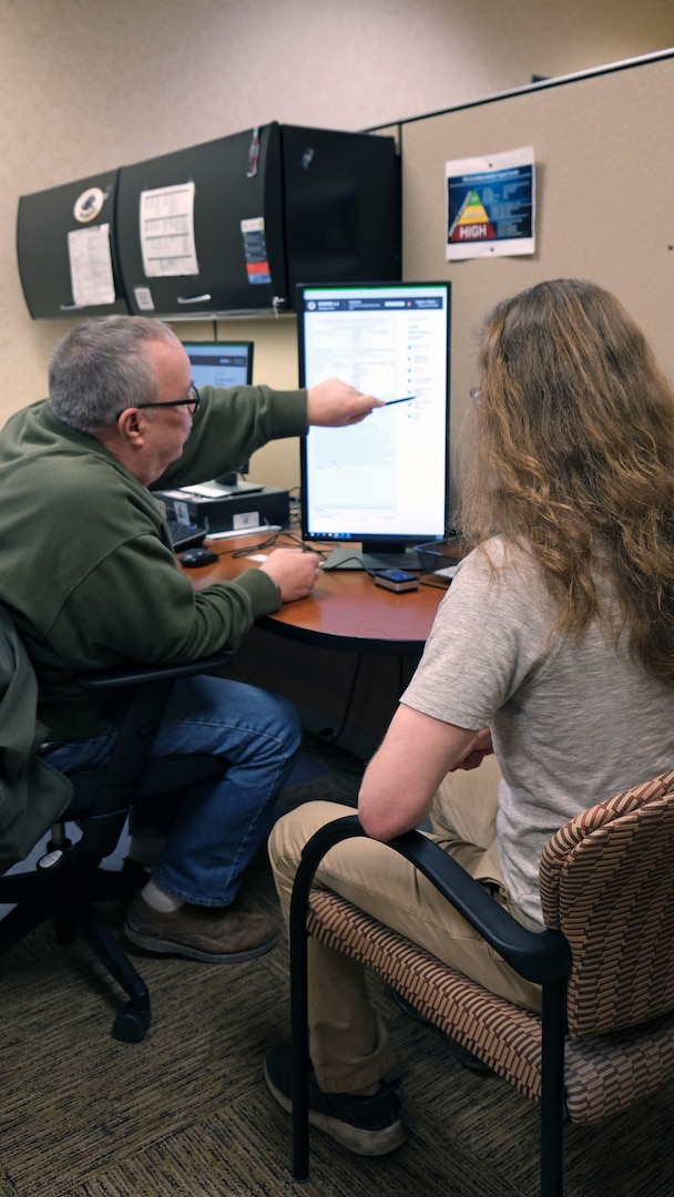 Eugene Polaski, human resources assistant, Milwaukee MEPS, reviews a contract on USMIRS 1.1 with an applicant during processing on Jan. 24. 2023.