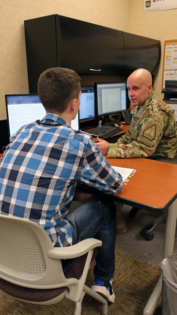 Army Staff Sgt. James Nelson, guidance counselor, Milwaukee MEPS, talks an applicant through signing his contract on USMIRS 1.1, Jan. 24 2023.