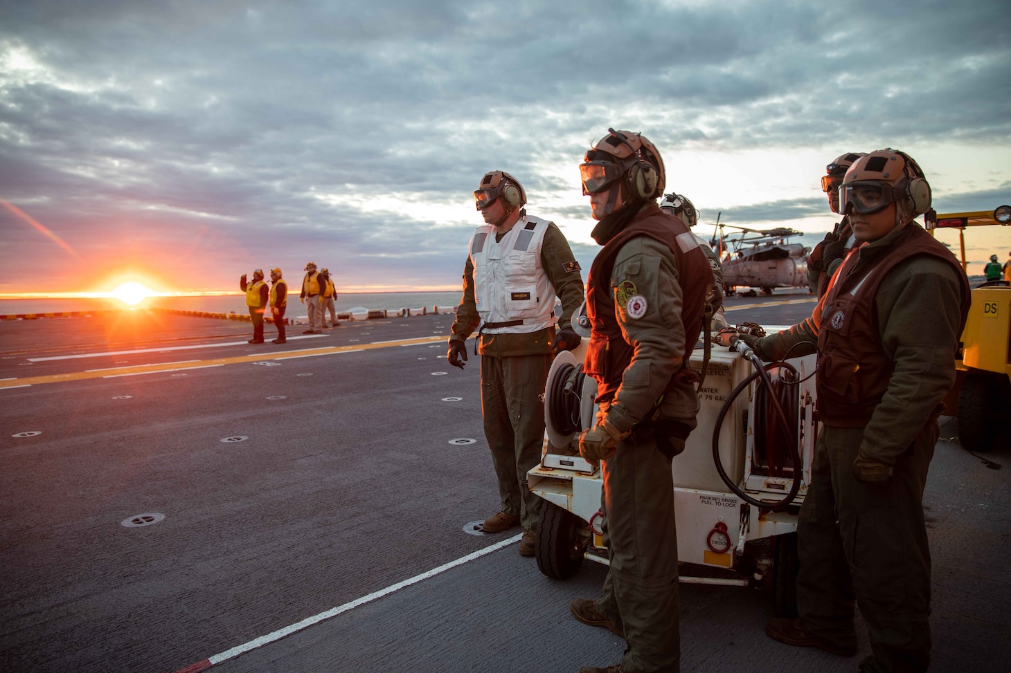 Wasp-class amphibious assault ship USS Bataan (LHD 5) Combat Cargo Department Marines stand by on the flight deck to receive aircraft during flight operations, Jan. 23, 2023.