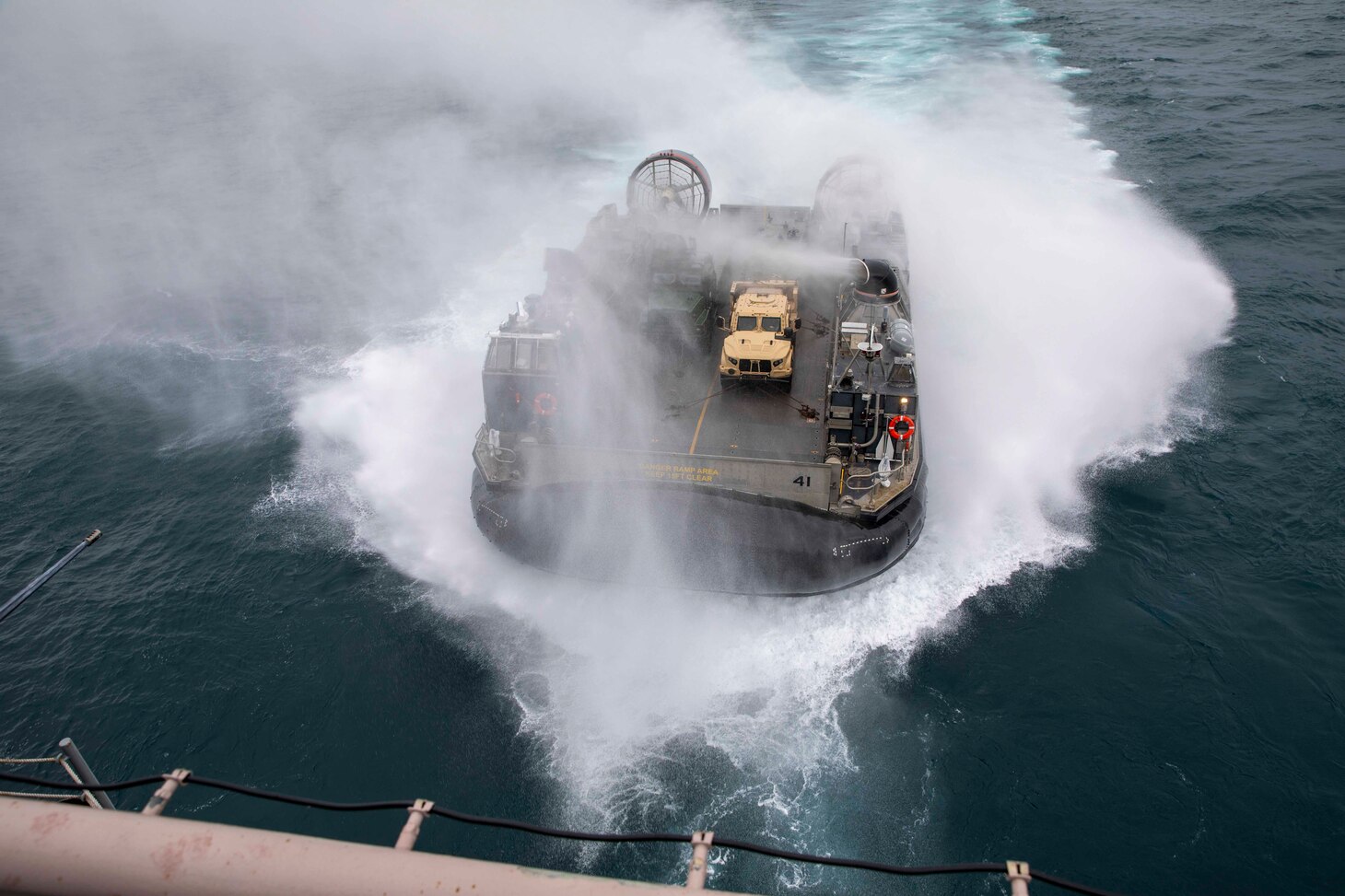 A Landing Craft Air Cushion assigned to Assault Craft Unit 4 prepares to come onboard the Wasp-class amphibious assault ship USS Bataan (LHD 5) to transport 26th Marine Expeditionary Unit’s (26th MEU) vehicles, Jan. 25, 2023.