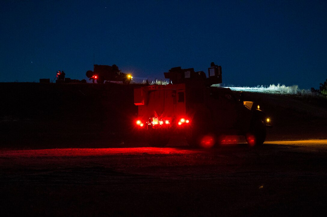 Military vehicles operate at night.
