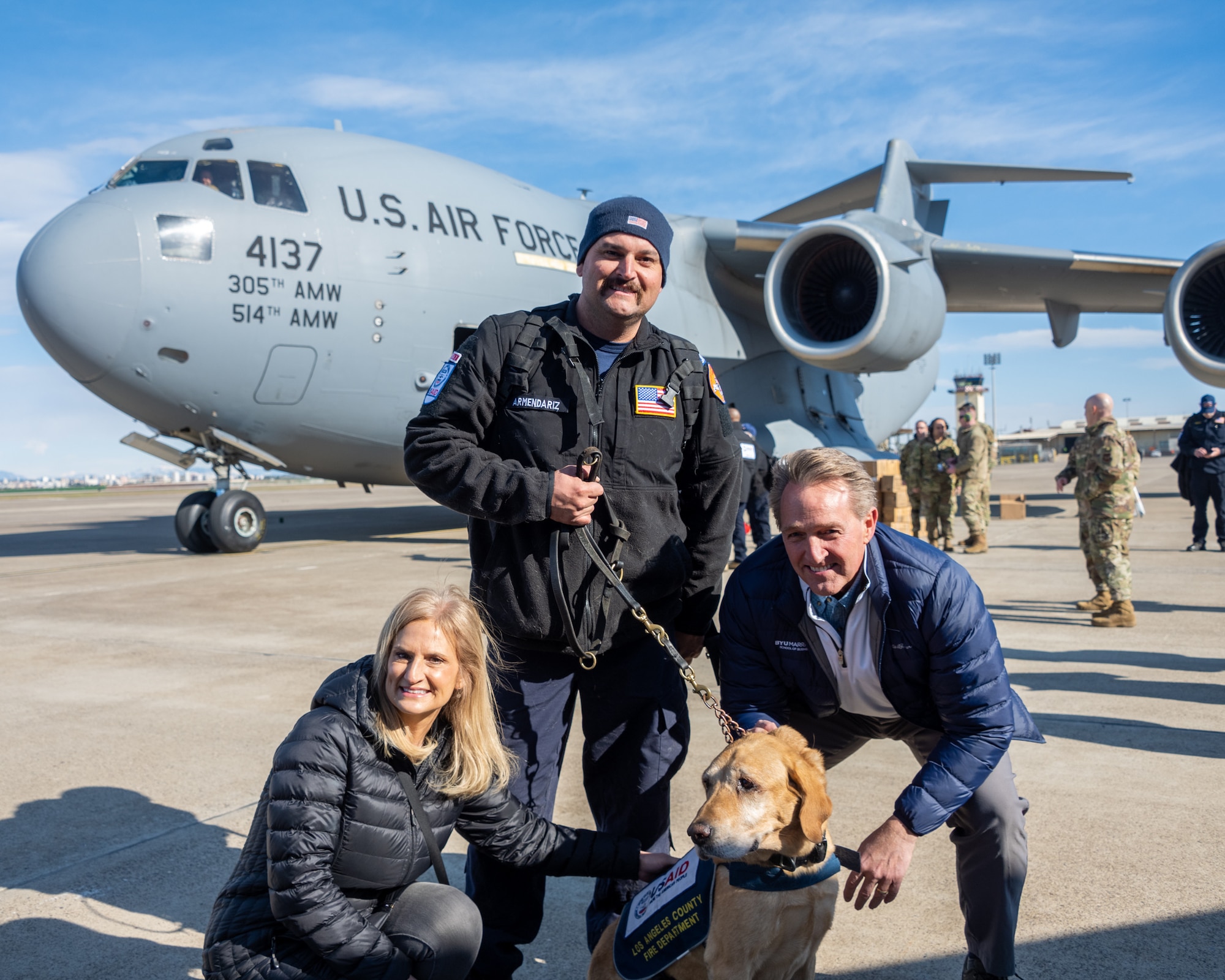 U.S. Ambassador Jeffry Flake, U.S. Ambassador to Türkiye, right, and Cheryl Flake, his wife, left, pose for a photo with a member of the United States Agency for International Development’s Disaster Assistance Response Team and his search and rescue dog after they arrived at Incirlik Air Base, Türkiye, Feb 8, 2023. Ambassador Flake visited Incirlik AB to greet members of the USAID team, following a series of earthquakes that struck central-southern Türkiye on Feb 6, 2023. As Ambassador to Türkiye, Flake holds the highest civilian position as The Chief of Mission, and impacts the communication and resources of U.S. personnel, advancing the U.S. foreign policy goals. As a fellow NATO ally, the U.S. Government mobilized personnel to assist in Türkiye in their response efforts. (U.S. Air Force photo by Senior Airman David D. McLoney)