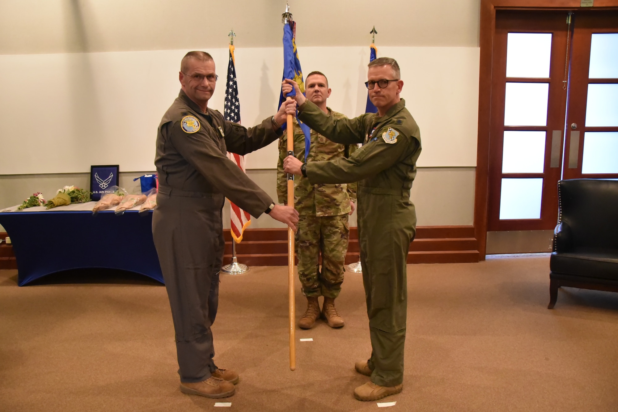 (Left to right) Lt. Col. Hendrikus "Dutch" Vanderveldt, incoming 931st Aerospace Medicine Squadron commander, receives the guidon from Col. Phil Heseltine, 931st Air Refueling Wing commander, at Bleckley Lounge.