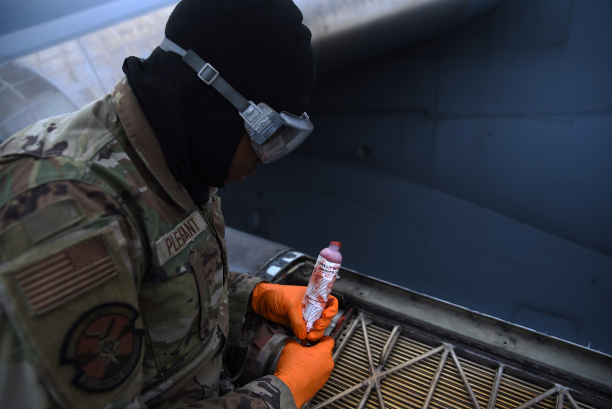 U.S. Air Force Airman 1st Class Kendall Pleasant, electrical and environmental journeyman with the 62d Aircraft Maintenance Squadron, applies sealant to a C-17 Globemaster III at Joint Base Lewis-McChord, Washington, Feb. 3, 2023. Sealant is used to reinforce aircraft parts to improve structural integrity and prevent the passage of air and fluids. (U.S. Air Force photo by Airman Kylee Tyus)