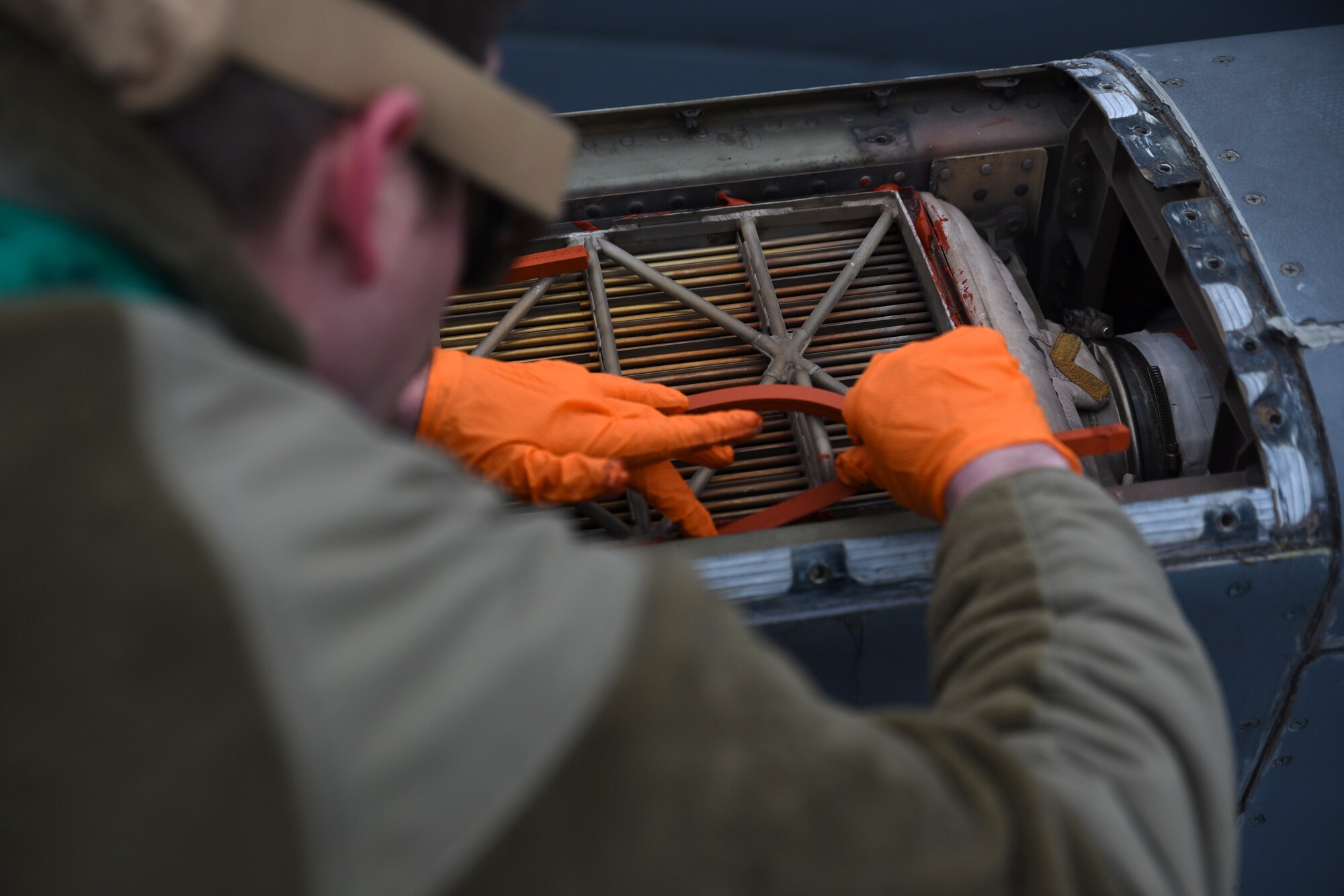 U.S. Air Force Airman 1st Class Travis Miller, electrical and environmental journeyman with the 62d Aircraft Maintenance Squadron, installs seals on an engine precooler on a C-17 Globemaster III at Joint Base Lewis-McChord, Washington, Feb. 3, 2023. Repairs performed by electrical and environmental Airmen ensure the C-17 Globemaster III stays mission ready at all times. (U.S. Air Force photo by Airman Kylee Tyus)