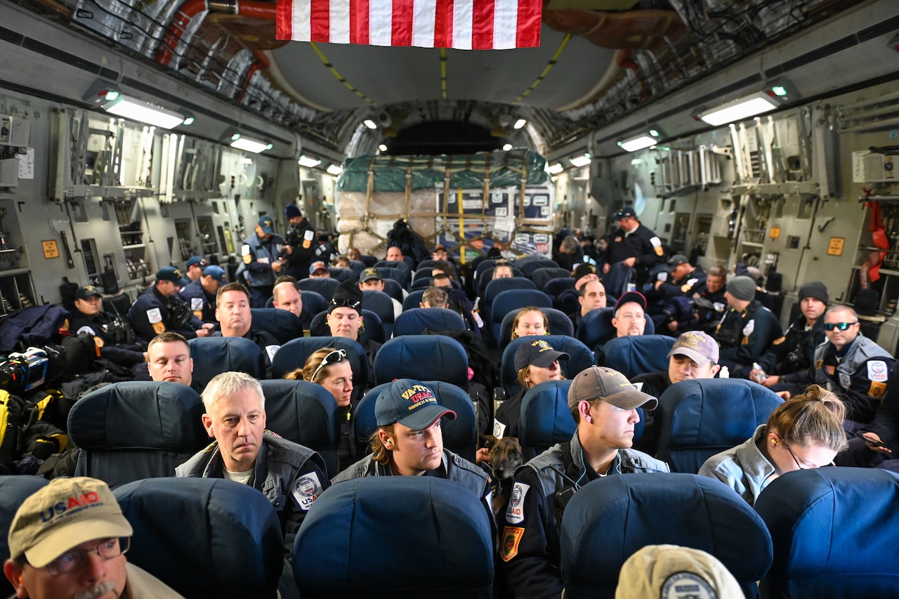 People are seated on an airplane.