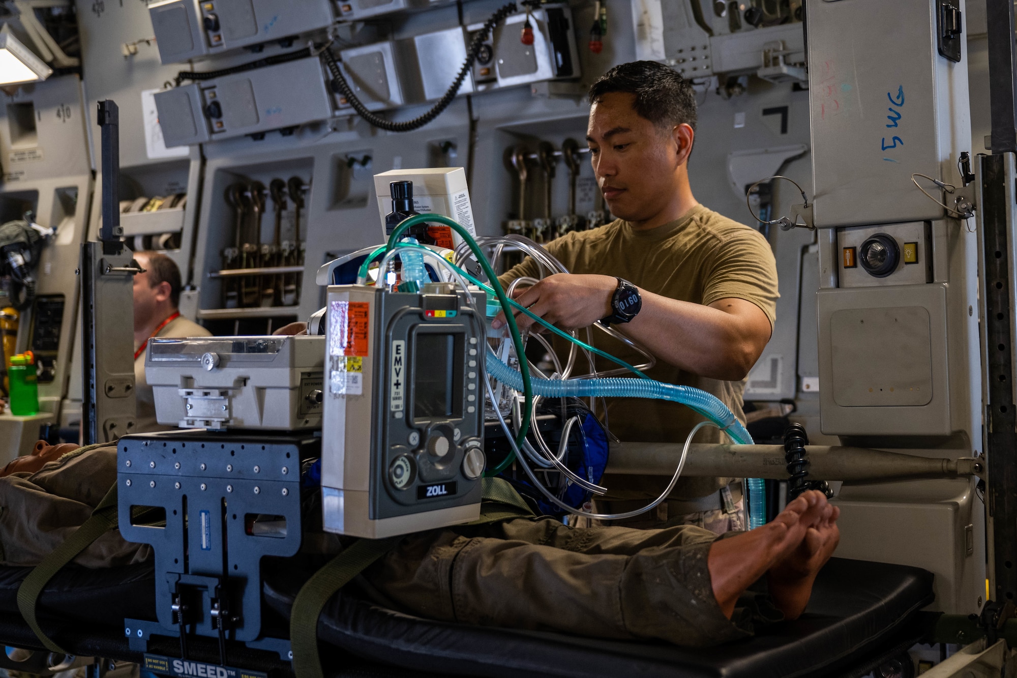 Master Sgt. Maynard Galves, Pacific Air Forces Critical Care Transport Team superintendent, secures equipment and a mock casualty during a Neonatal and Critical Care Air Transport Team training at Joint Base Pearl Harbor-Hickam, Feb. 6, 2022. The CCAT team is a three-person team that helps prepare, monitor and transport critically injured patients to receive the care they need, turning an aircraft into a flying intensive care unit. (U.S. Air Force photo by Senior Airman Makensie Cooper)