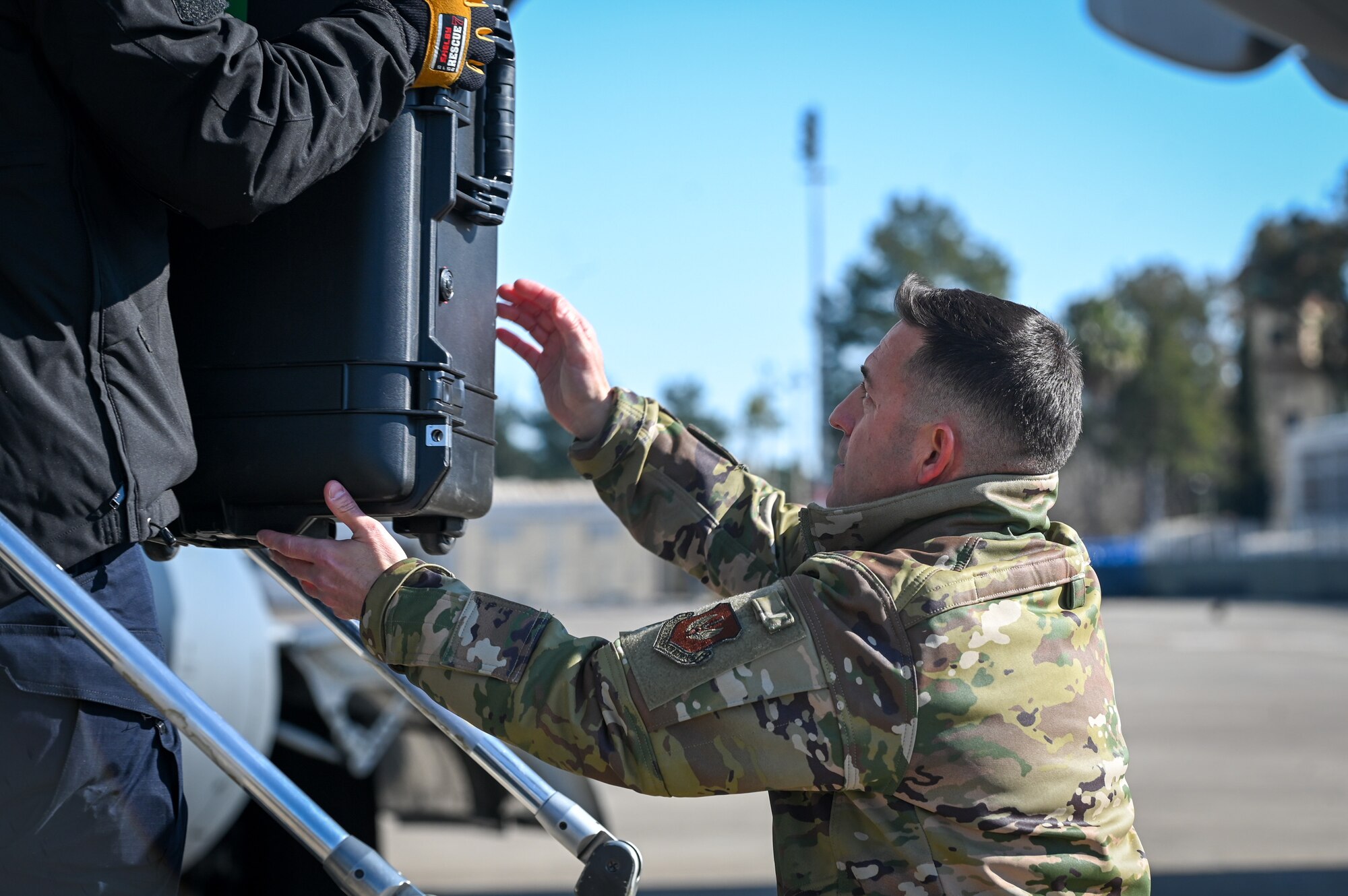 Chief Master Sgt. Justin Stoltzfus, 39th Air Base Wing command chief, assists members of the United States Agency for International Development’s Disaster Assistance Response Team with unloading equipment at Incirlik Air Base, Türkiye, Feb. 8, 2023.