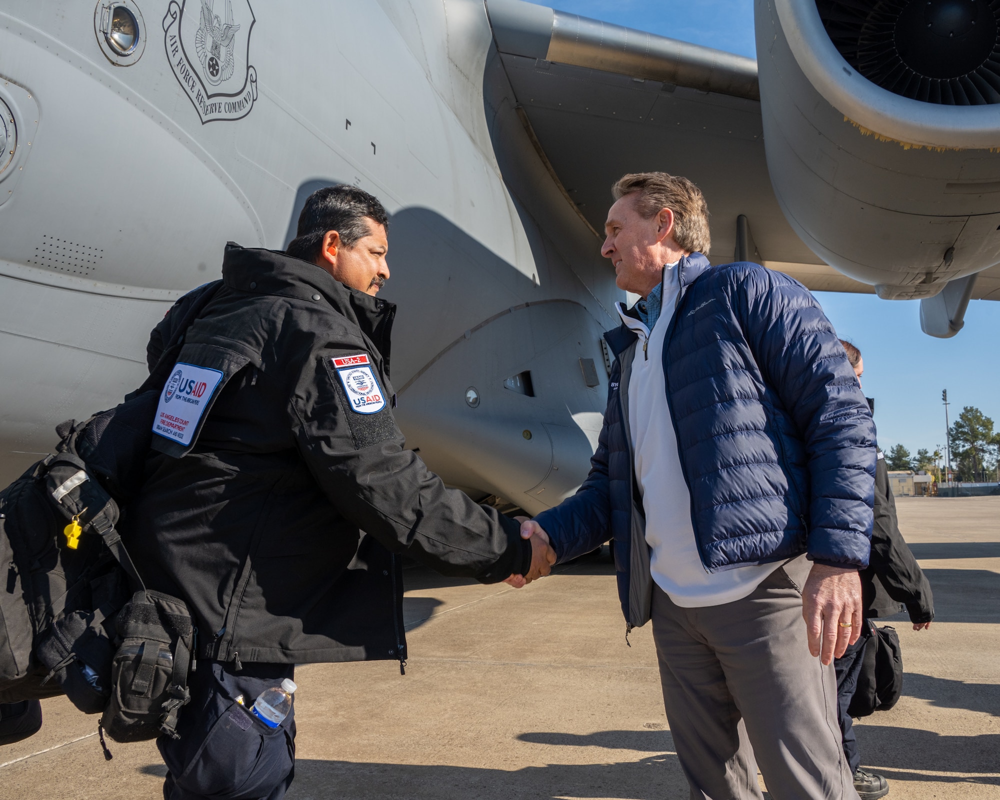 U.S. Ambassador Jeffry Flake, U.S. Ambassador to Türkiye, right, shakes hands with a member of the United States Agency for International Development’s Disaster Assistance Response Team, left, during their arrival at Incirlik Air Base, Türkiye, Feb 8, 2023. Ambassador Flake visited Incirlik AB to greet members of the USAID team, following a series of earthquakes that struck central-southern Türkiye on Feb 6, 2023. As Ambassador to Türkiye, Flake holds the highest civilian position as The Chief of Mission, and impacts the communication and resources of U.S. personnel, advancing the U.S. foreign policy goals. As a fellow NATO ally, the U.S. Government mobilized personnel to assist in Türkiye in their response efforts. (U.S. Air Force photo by Senior Airman David D. McLoney)