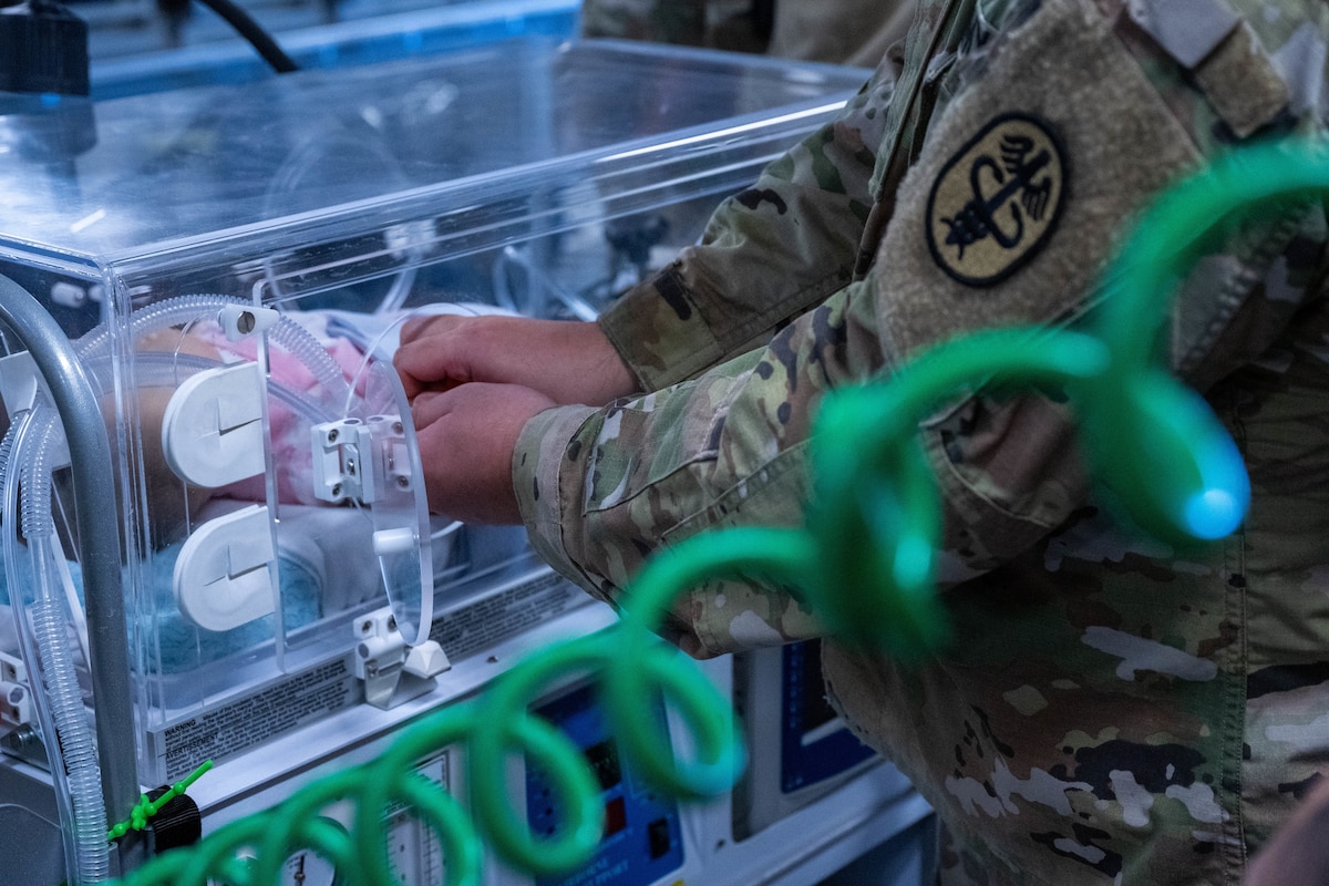 A Soldier from Tripler Army Medical Center checks respiratory equipment on a neonatal intensive care unit during a training on a C-17 Globemaster III at Joint Base Pearl Harbor-Hickam, Hawaii, Feb. 6, 2022. The training focused on safely and efficiently loading and securing a NICU transport system and critically injured patients onto a C-17 Globemaster III. (U.S. Air Force photo by Senior Airman Makensie Cooper)