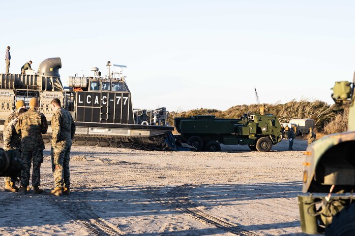 A U.S. Marine Corps High Mobility Artillery Rocket System assigned to Sierra Battery, Battalion Landing Team, 26th Marine Expeditionary Unit, is loaded onto a U.S. Navy Landing Craft, Air Cushion (LCAC) during Amphibious Squadron/Marine Expeditionary Unit Integration (PMINT) exercise on Marine Corps Base Camp Lejeune, North Carolina. During PMINT, the 26th MEU loaded a HIMARS onto a LCAC where it was transported from ship-to-shore onto the USS Mesa Verde (LPD 19) off the coast marking this as the first instance of a MEU utilizing this system for deployment. (U.S. Marine Corps photo by Staff Sgt. Jesus Sepulveda Torres)