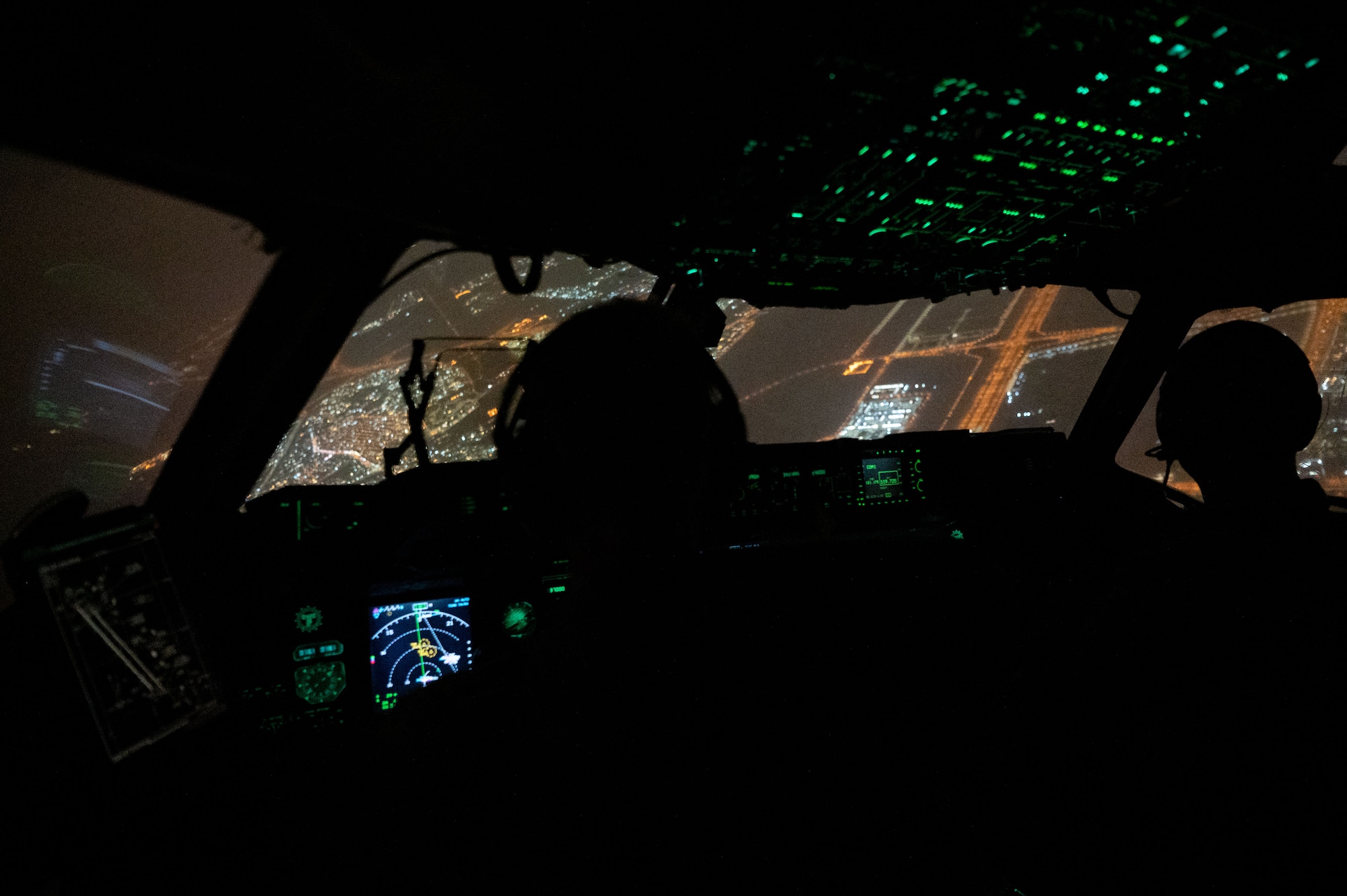 Photo of pilots approaching a runway at night