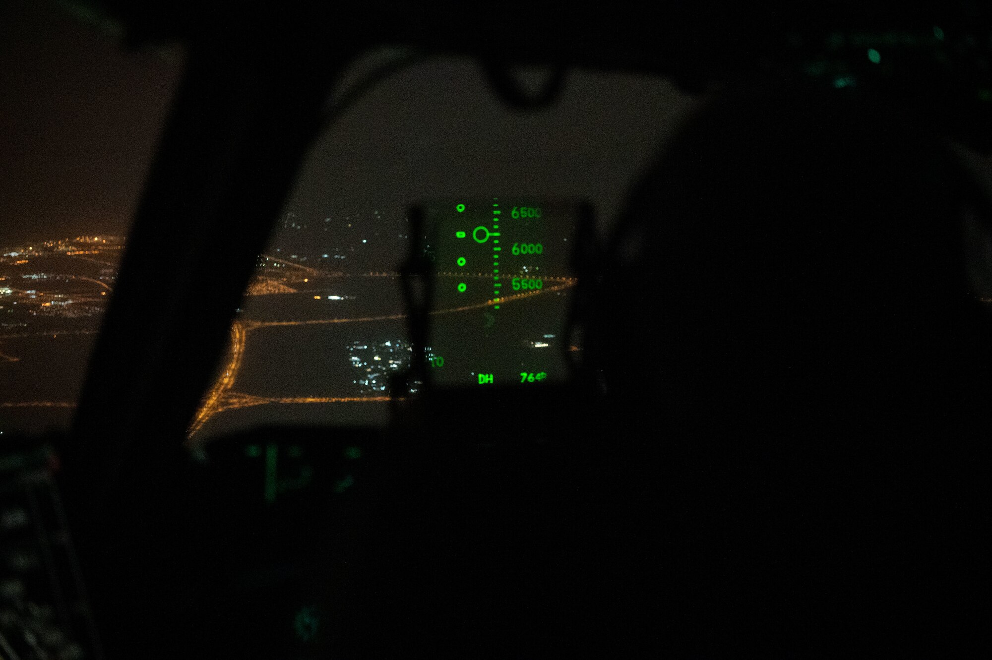 Photo of a pilot landing on a runway at night
