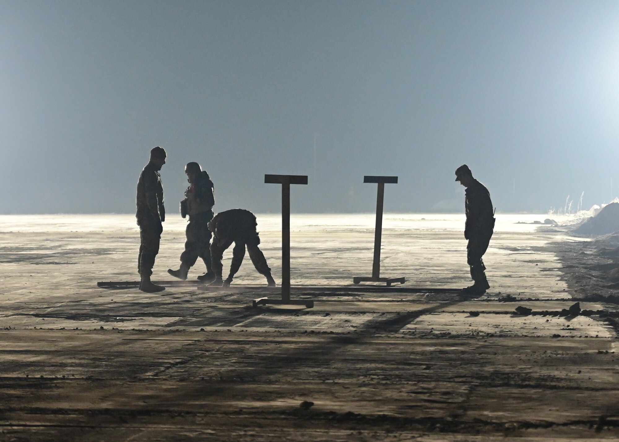 U.S. Air Force service members from the 8th Civil Engineer Squadron (CES) mark and inspect simulated damage during rapid airfield damage repair (RADR) training at Kunsan Air Base, Republic of Korea, Feb. 7, 2023. The 8th CES RADR teams assessed simulated airfield craters, made repairs and proved their ability to ensure flightline operability. (U.S. Air Force photo by Staff Sgt. Isaiah J. Soliz)