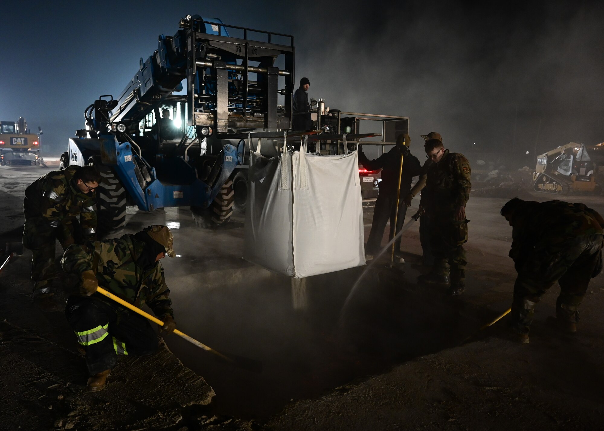 U.S. Air Force engineers assigned to the 8th Civil Engineer Squadron (CES) empty a cement mixture during rapid airfield damage repair (RADR) training at Kunsan Air Base, Republic of Korea, Feb. 7, 2023. In the event of an attack, the 8th CES “Dirt Boys” are trained to quickly return the airfield to full mission capability. (U.S. Air Force photo by Staff Sgt. Isaiah J. Soliz)