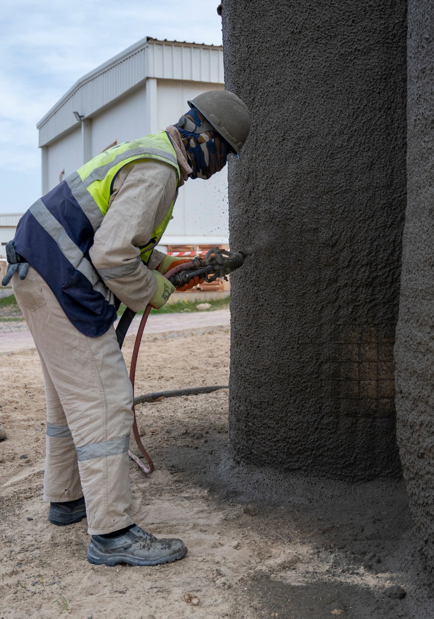 Muhammad Ijaz, a Prime One contractor, sprays concrete onto a new bunker at Ali Al Salem Air Base, Kuwait, Feb. 7, 2023.