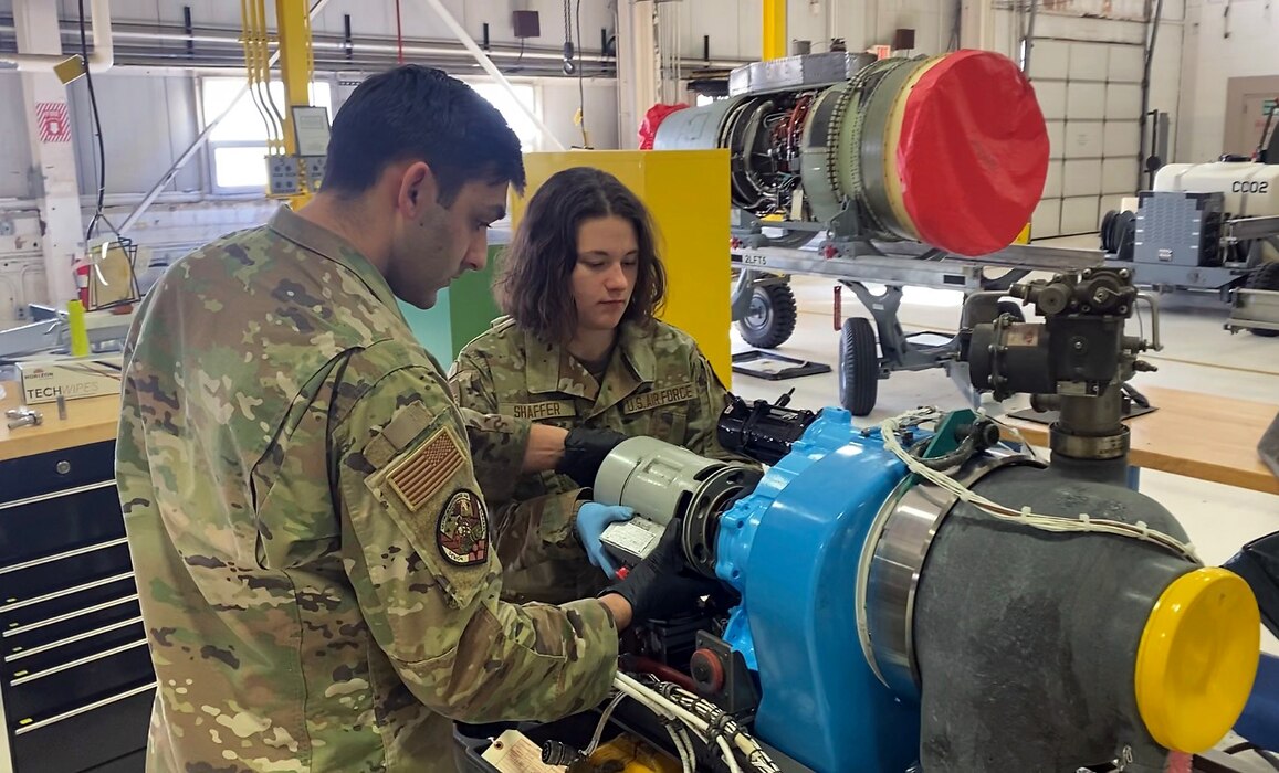 Airman 1st Class Nea Shafer and Senior Airman Jon Jreige work together to install a generator on an auxiliary power unit used on A-10 Thunderbolt II aircraft at Selfridge Air National Guard Base, Michigan, Feb. 4, 2023. Both Airmen are aerospace propulsion technicians assigned to the 127th Maintenance Squadron at the base. Jreirge works full time at the base. Shafer is a full-time student at Eastern Michigan University and serves part time as a member of the Michigan Air National Guard. (U.S. Air National Guard photo by Master Sgt. Dan Heaton)