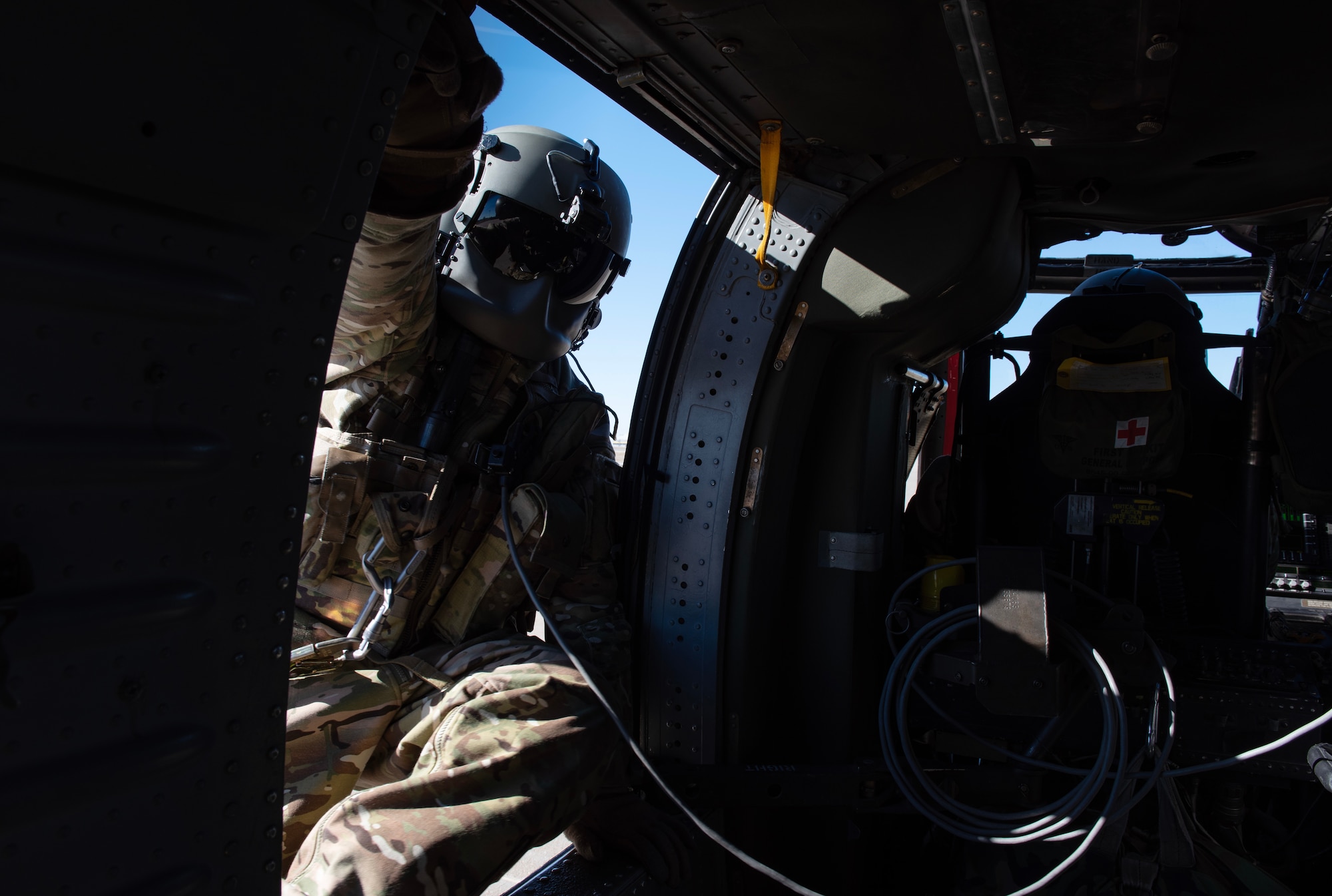 A U.S. Army Soldier from the 3rd Assault Helicopter Battalion, 1st Aviation Regiment at Fort Riley, Kansas, climbs into a UH-60 Blackhawk during joint training at McConnell Air Force Base, Kansas, Feb. 3, 2023. Airmen from the 22nd Security Forces Squadron trained with the Soldiers to practice tactical takeoffs and landings in the Blackhawk. (U.S. Air Force photo by Staff Sgt. Tryphena Mayhugh)