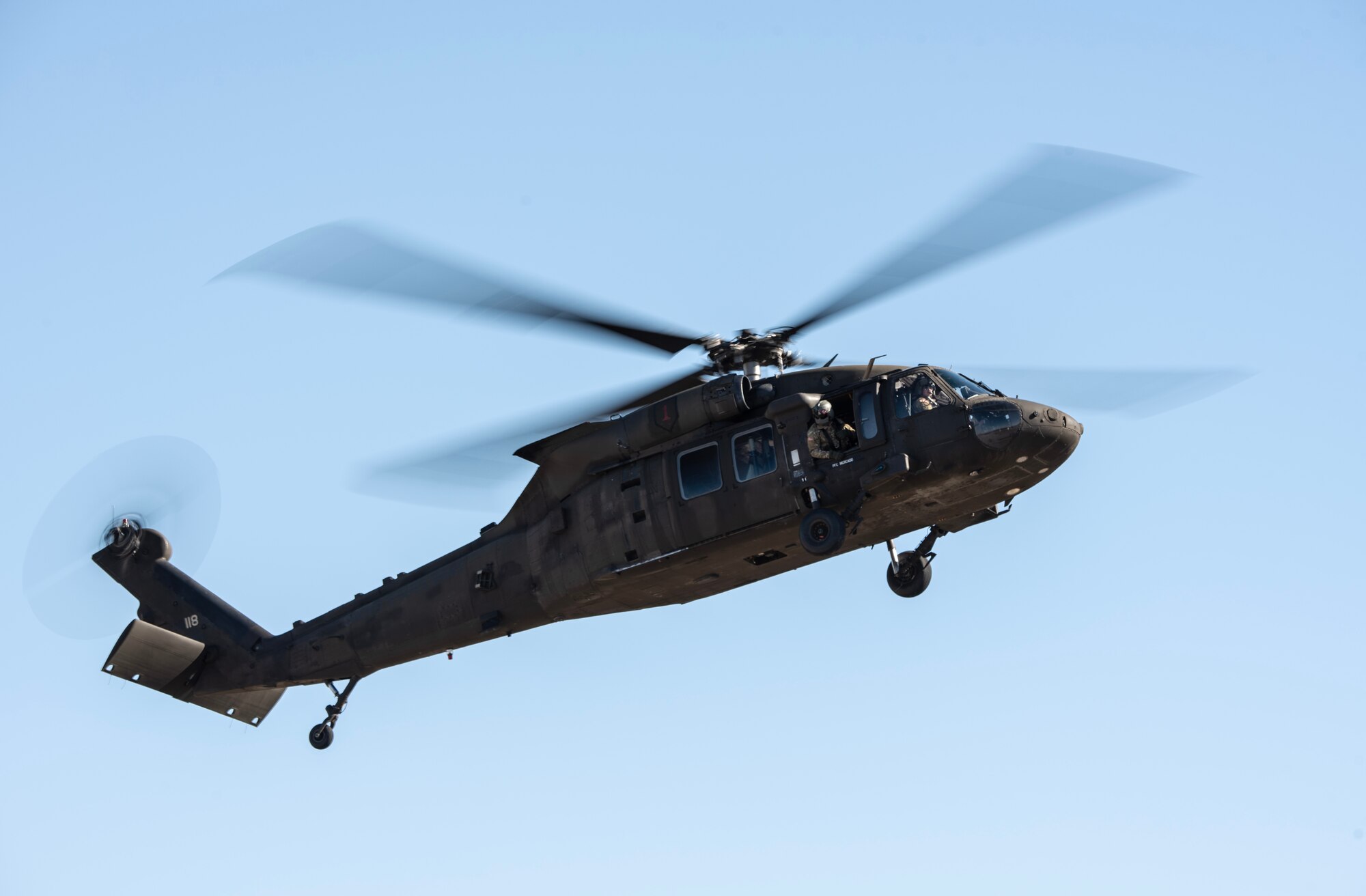 U.S. Army Soldiers from the 3rd Assault Helicopter Battalion, 1st Aviation Regiment UH-60 Blackhawk prepare to land a UH-60 Blackhawk during joint training at McConnell Air Force Base, Kansas, Feb. 3, 2023. Airmen from the 22nd Security Forces Squadron trained with the Soldiers to practice tactical takeoffs and landing in the Blackhawk. (U.S. Air Force photo by Staff Sgt. Tryphena Mayhugh)