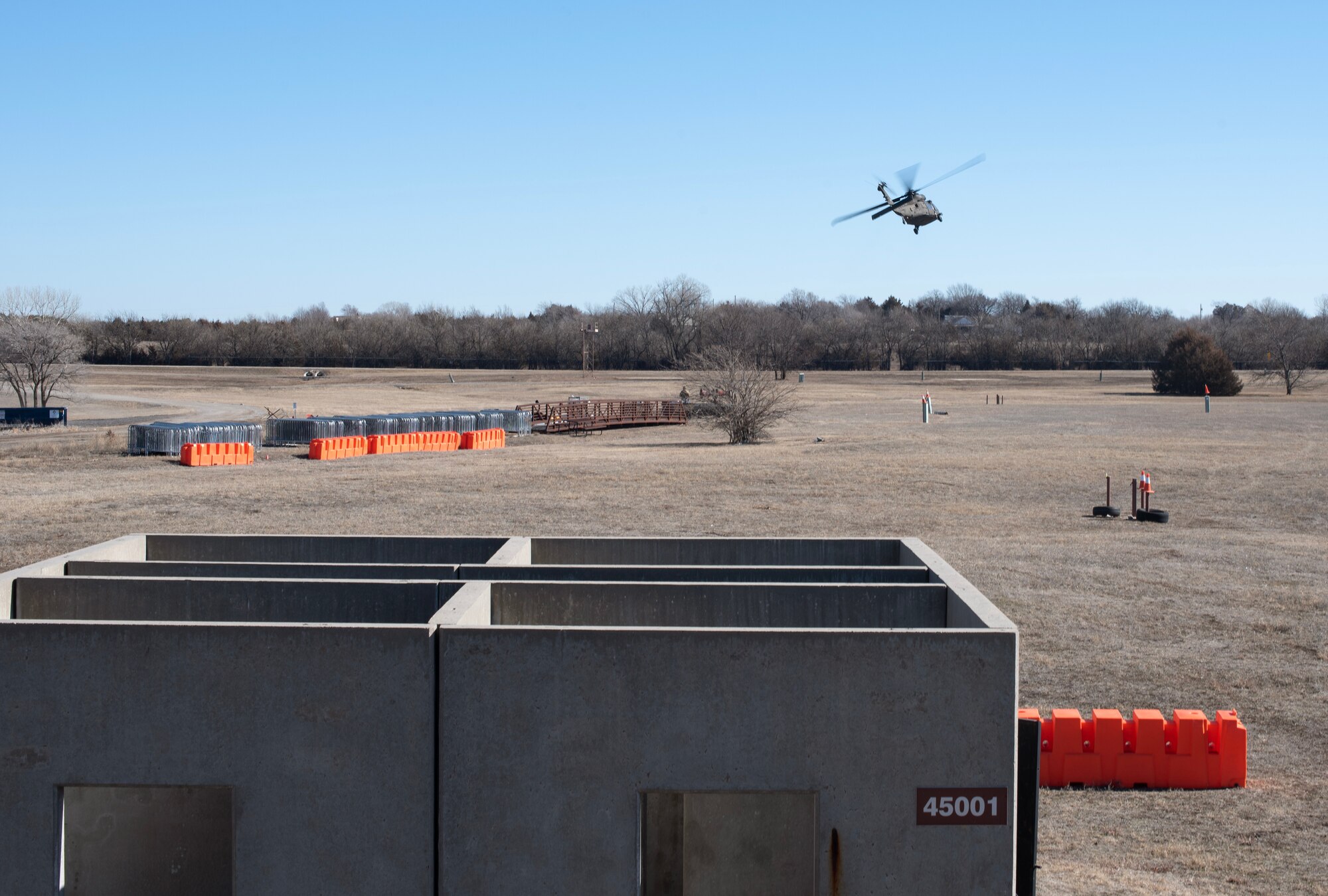A U.S. Army UH-60 Blackhawk flies over the 22nd Security Forces Squadron’s training area during joint training at McConnell Air Force Base, Kansas, Feb. 3, 2023. Airmen from the squadron trained with Soldiers from the 3rd Assault Helicopter Battalion, 1st Aviation Regiment from Fort Riley, Kansas, to practice tactical takeoffs and landings in the Blackhawk. (U.S. Air Force photo by Staff Sgt. Tryphena Mayhugh)